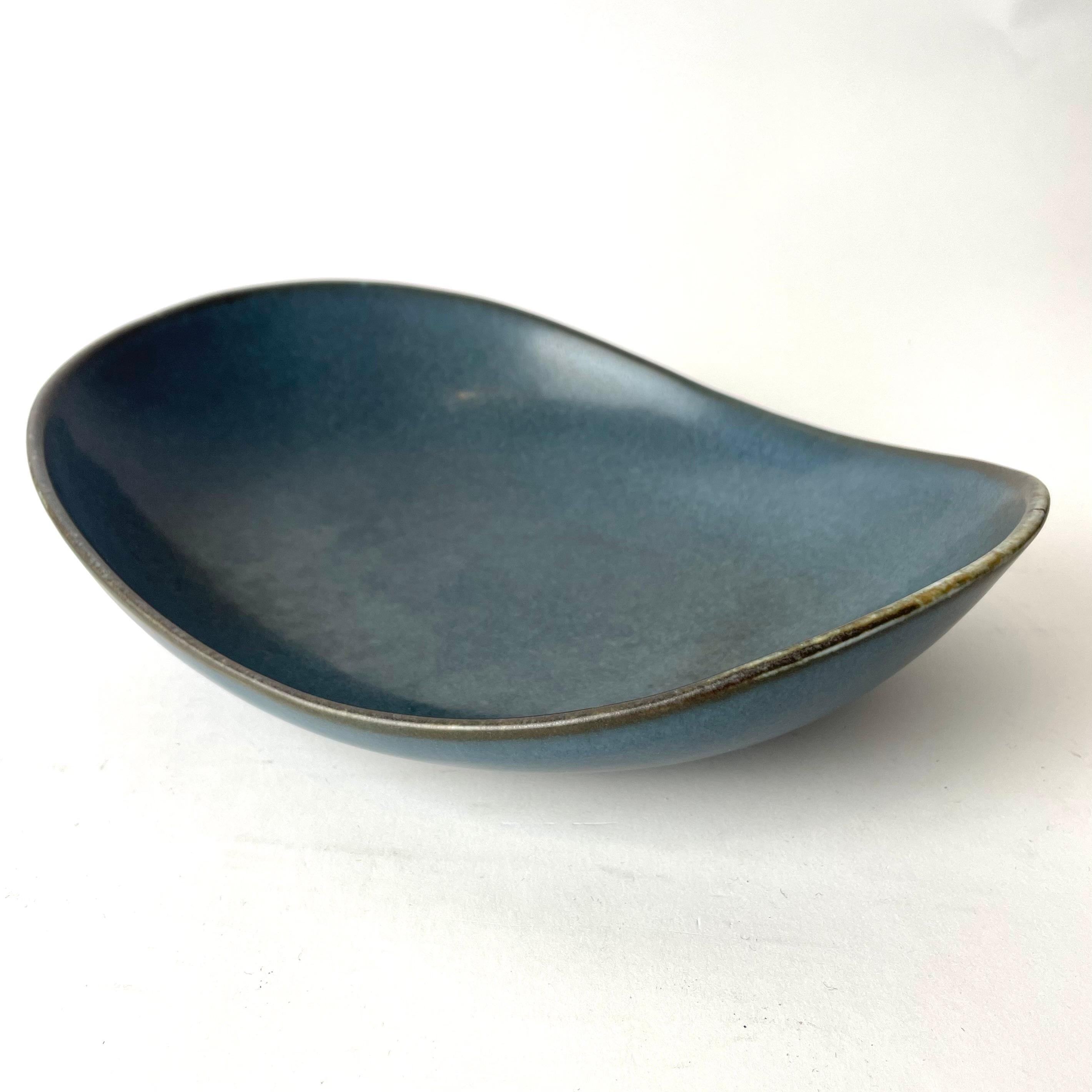 Swedish Scandinavian Decorative Dish Bowl designed by prominent Swedish designer Carl-Harry Stålhane for the Rörstrand company in Sweden.

This decorative bowl features a blue mettled appearance, complemented by edges in tones of green and brown.