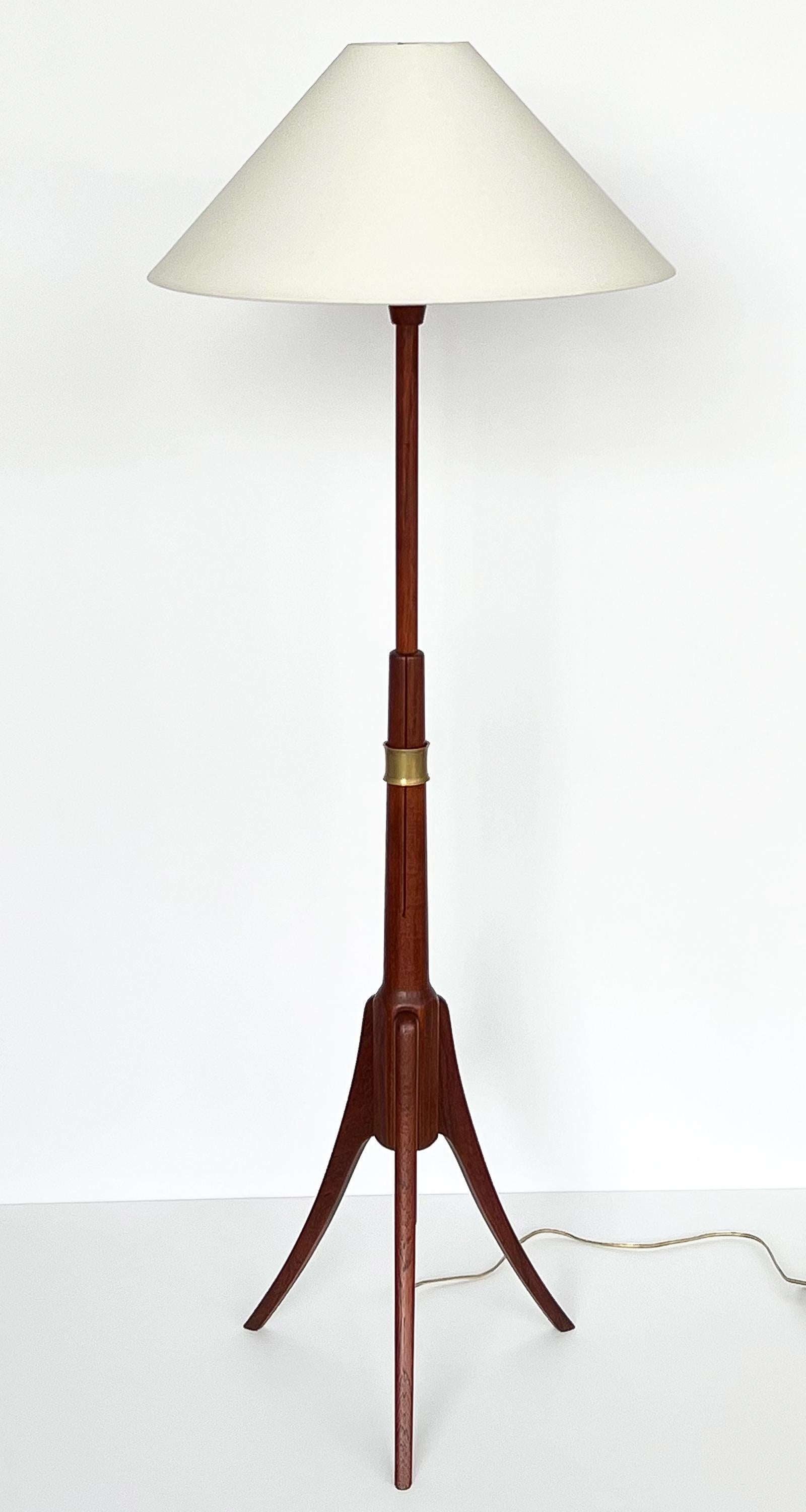 A unique mid century adjustable teak and brass floor lamp, Sweden circa 1950s. Solid teak construction with flared tripod base. Clothespin shaped stem with 1.25