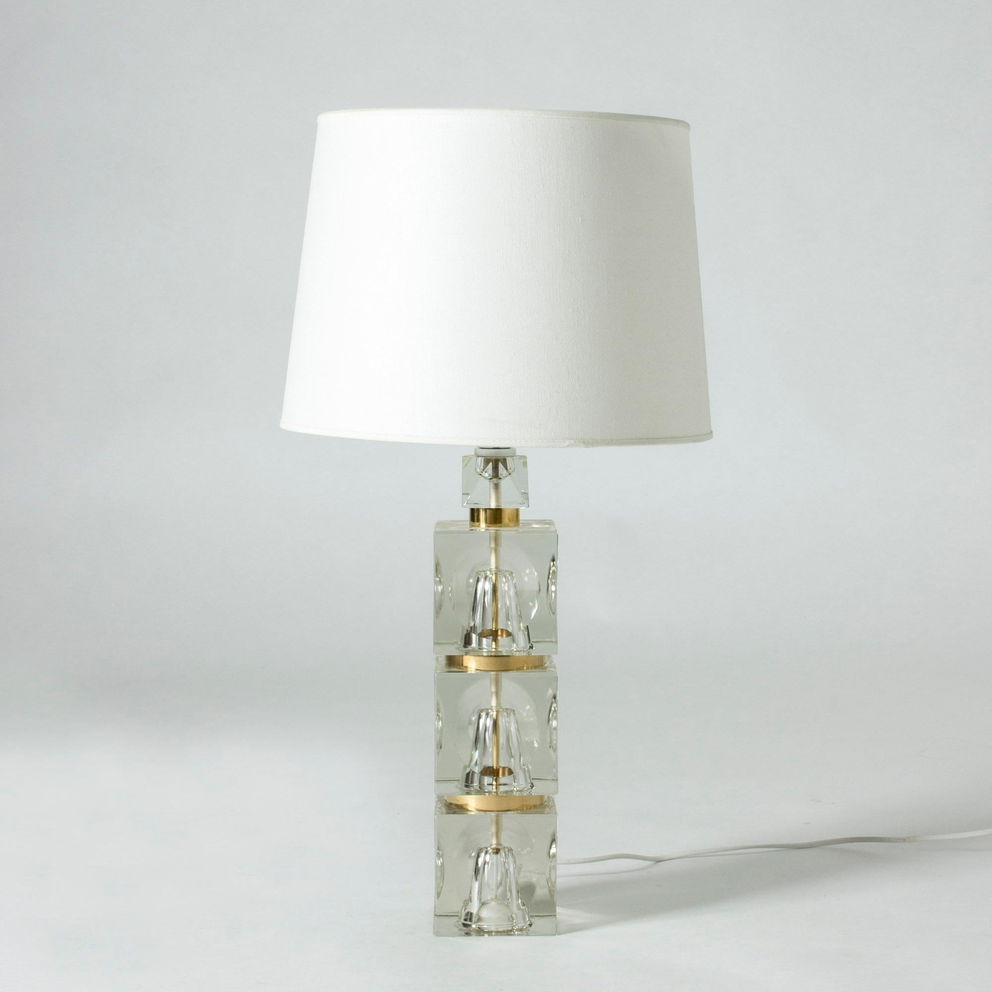 Cool Swedish 1960s crystal table lamp. Chunky base of stacked cubes with concave spherical cuts creating an interesting visual effect. The spaces between the cubes are painted gold.