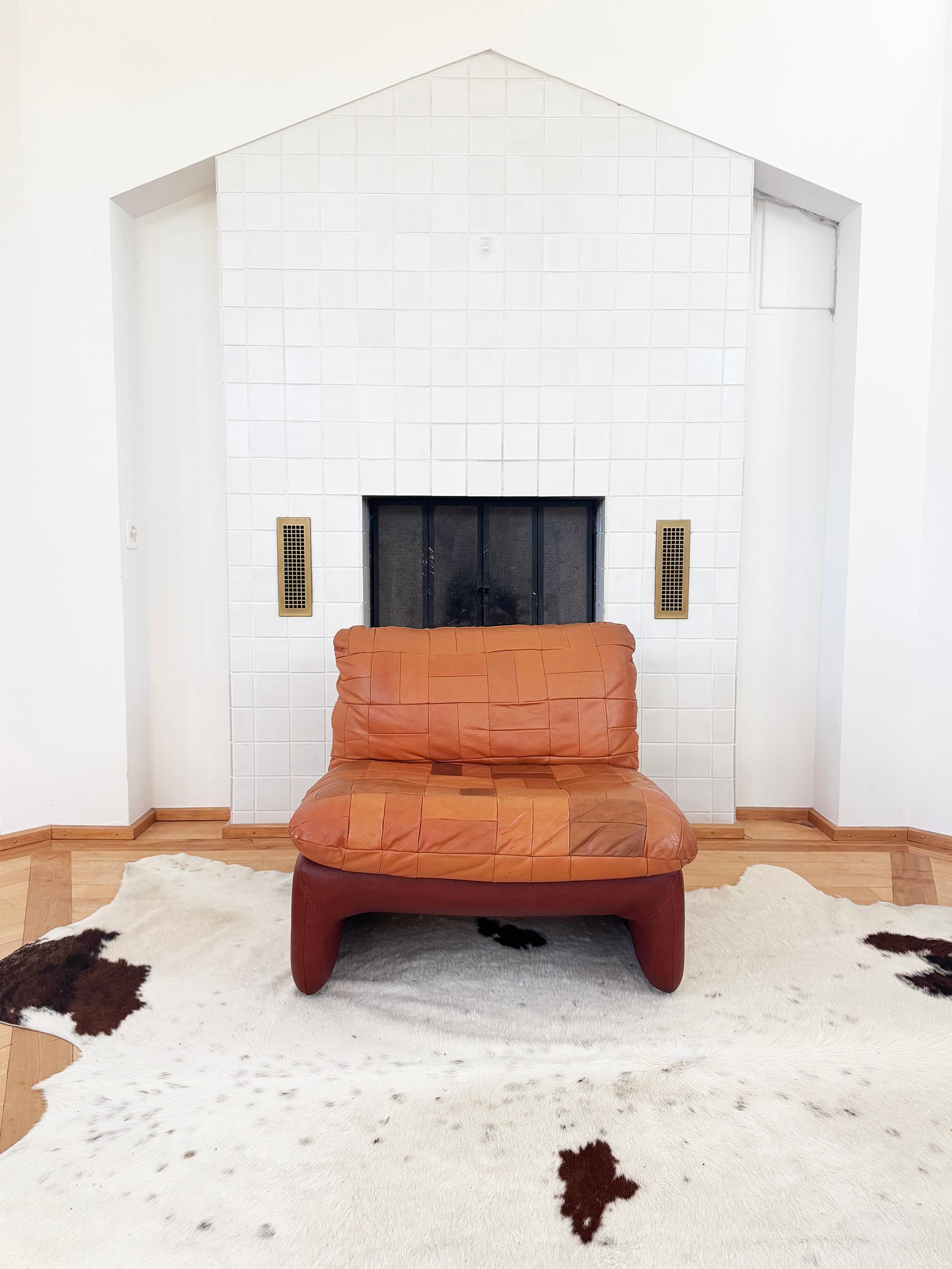 One very gorgeous sculptural lounge chair manufactured by Overman of Sweden (ca. early 1970s). Patchwork leather 'sling' seat sewn to brown vinyl frame. Original soft and supple leather with beautiful patina in fantastic condition.  There is a