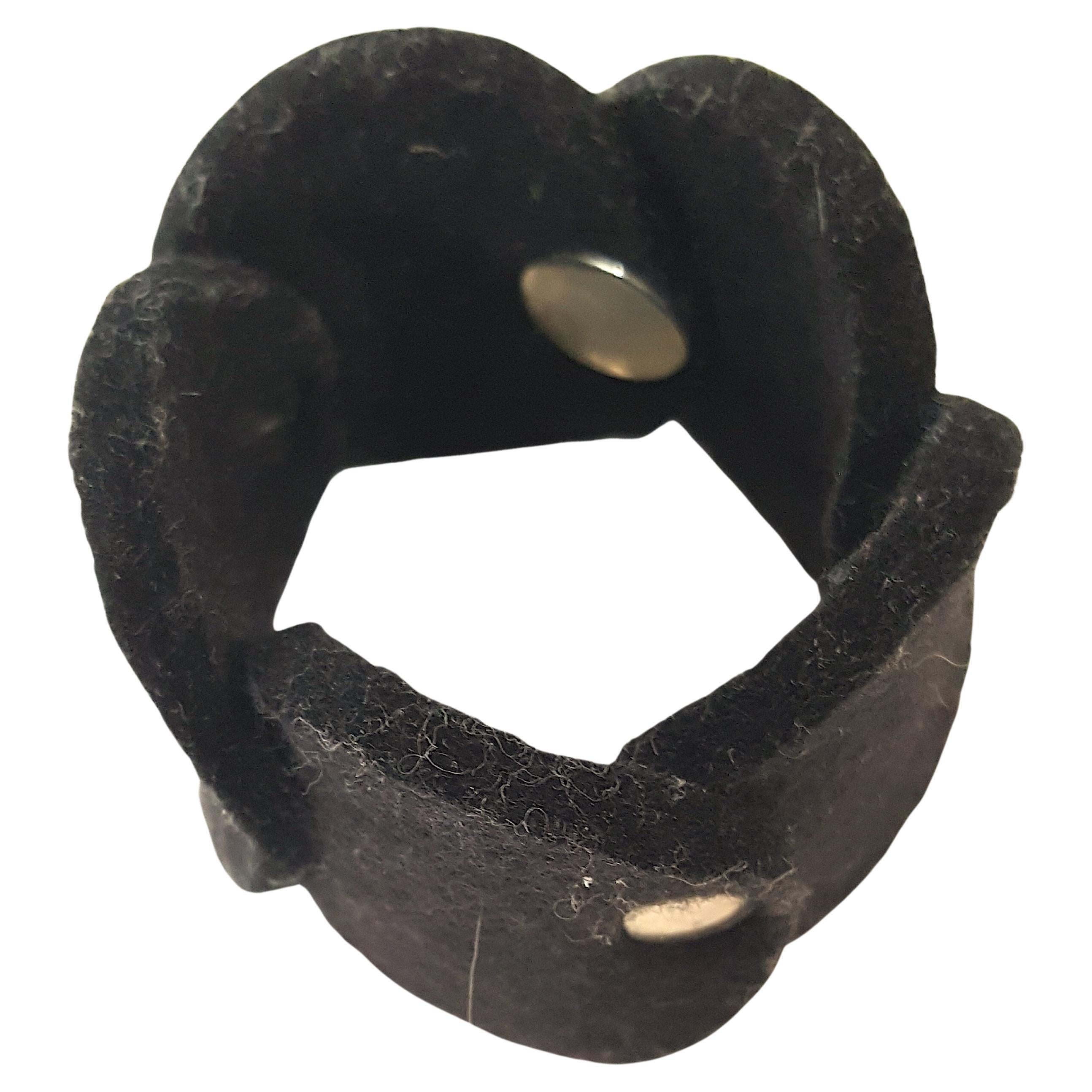 Die schwedische Künstlerin Pia Wallen hat dieses moderne, kühne schwarze Gliederarmband mit überlappenden Scheiben aus ihren charakteristischen dicken 
100%-Wollfilz, der mit silbernen Rundbeschlägen für den Innenschnappverschluss an der mit 