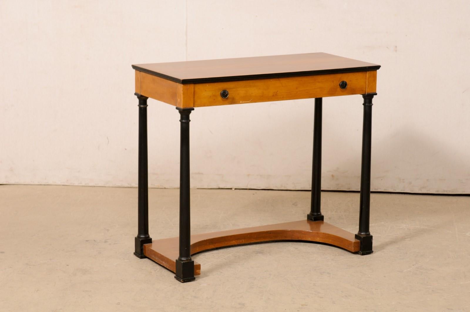 A Swedish small-sized wooden console table with drawer from the 19th century. This antique table from Sweden has a rectangular-shaped top (approximately 2.75 feet in length) with sits atop an apron that houses a single door which spans the width of
