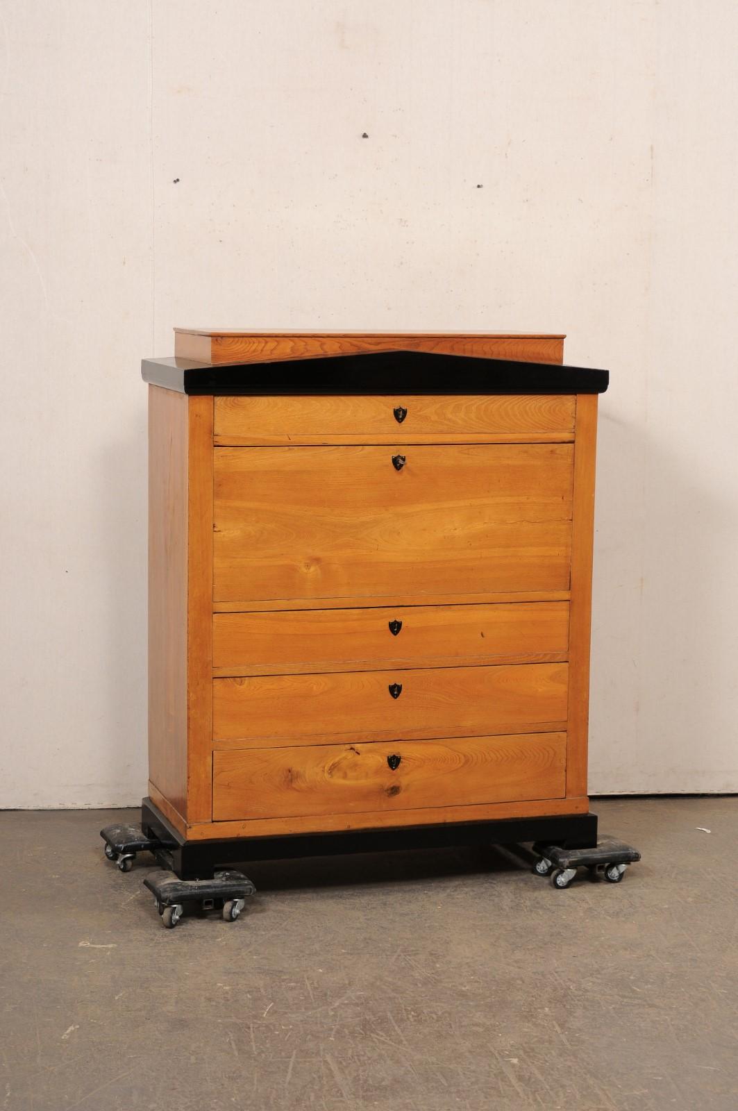A Swedish Empire style chest with secretary from the 19th century. This antique case piece from Sweden has been designed in Swedish Empire style with a wonderful architectural appearance that is emphasized with an ebony pediment at top and ebony