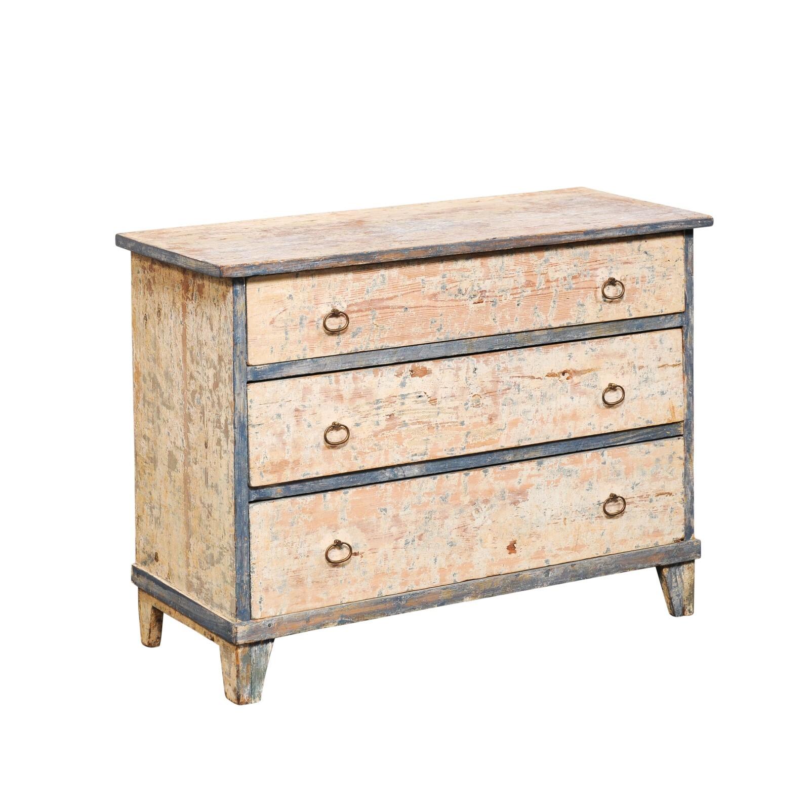 A Swedish Gustavian style wooden chest of three drawers from the 19th century. This antique chest from Sweden has been designed with clean, minimal stylings typical in Gustavian furniture. The rectangular top slightly overhangs the case below, which