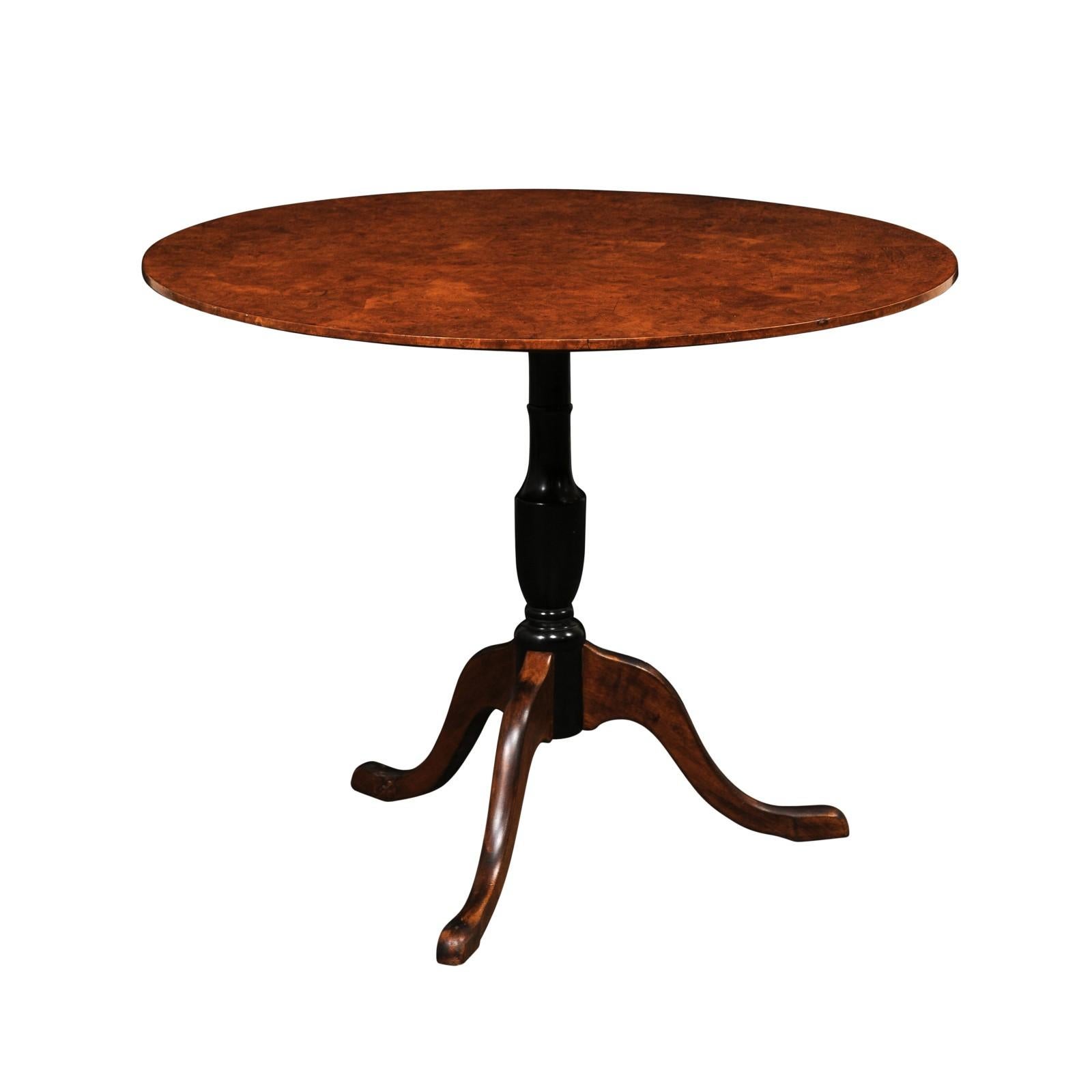 A Swedish burled alder wood pedestal table with tilt-top from the late 19th century. This antique table from Sweden features a round-shaped tilt top with a wonderful burled alder veneer, which rests upon a nicely turned central column (in