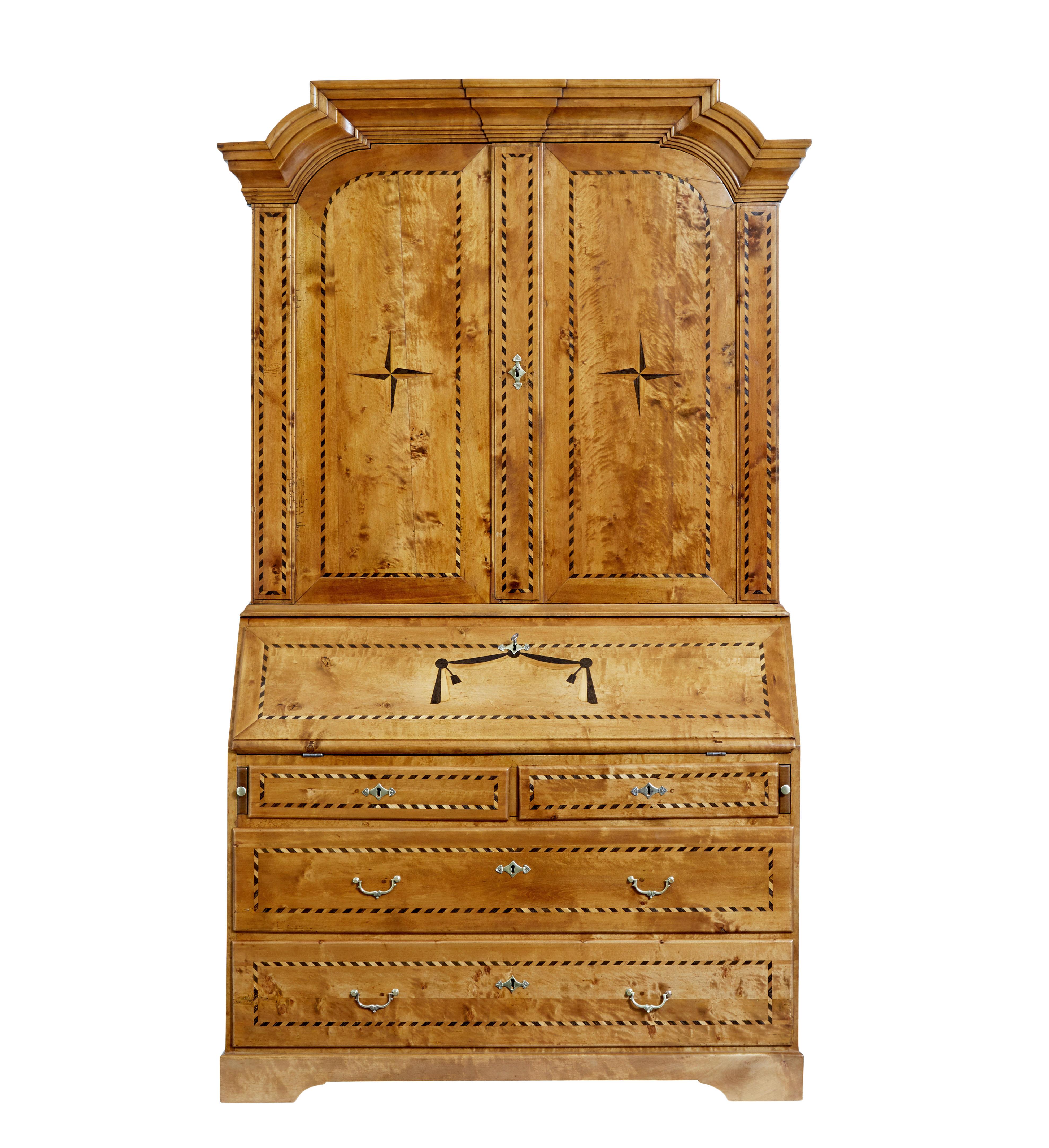 Swedish 19th century birch inlaid bureau bookcase circa 1870.

Good quality swedish bureau bookcase of grand proportions.  Comprising of 2 parts, upper cupboard and the bureau and drawers.

Top section surmounted with a shaped architectural