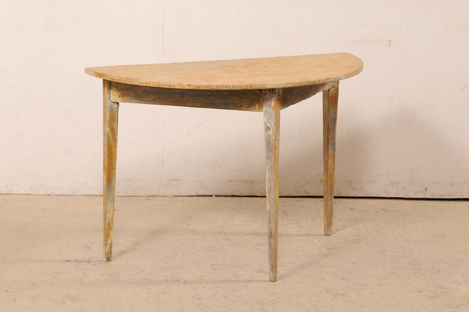 A single Swedish wooden demi-lune table from the 19th century. This antique table from Sweden, circa 1880's, features a semi-circular top over a plain triangular shaped apron, and is raised upon three squared and gently tapered legs. The table has