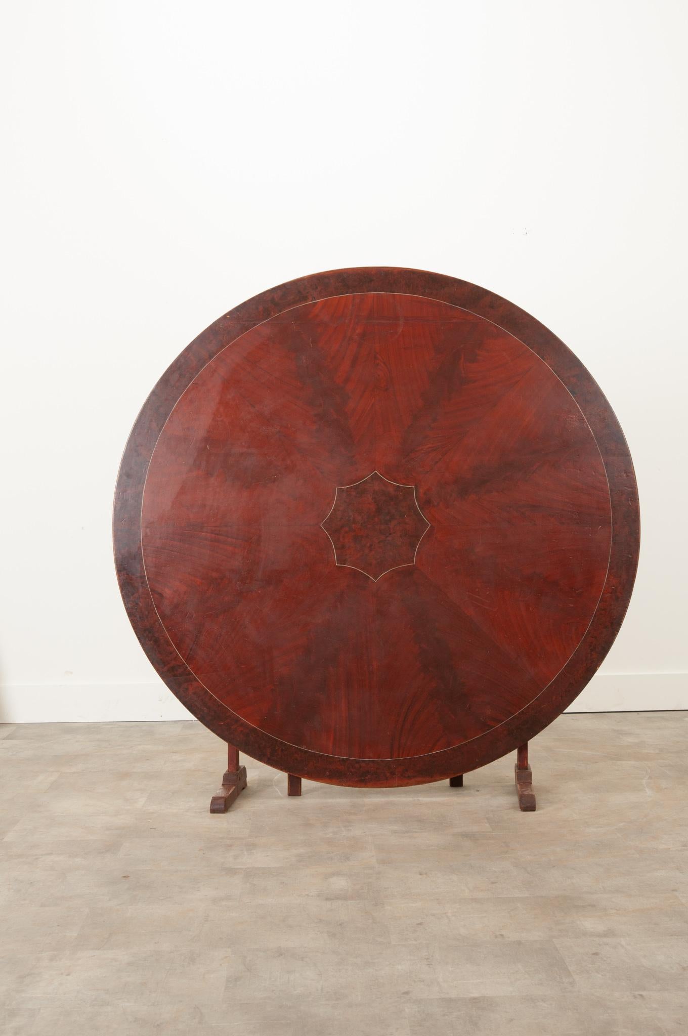 An impressive 19th century Swedish gateleg tilt top table. Eight pointed starburst in the center and an encompassing border, done in light gray paint, accentuates the slight differences in the wood grain. Supported by a gateleg, it’s incredibly easy