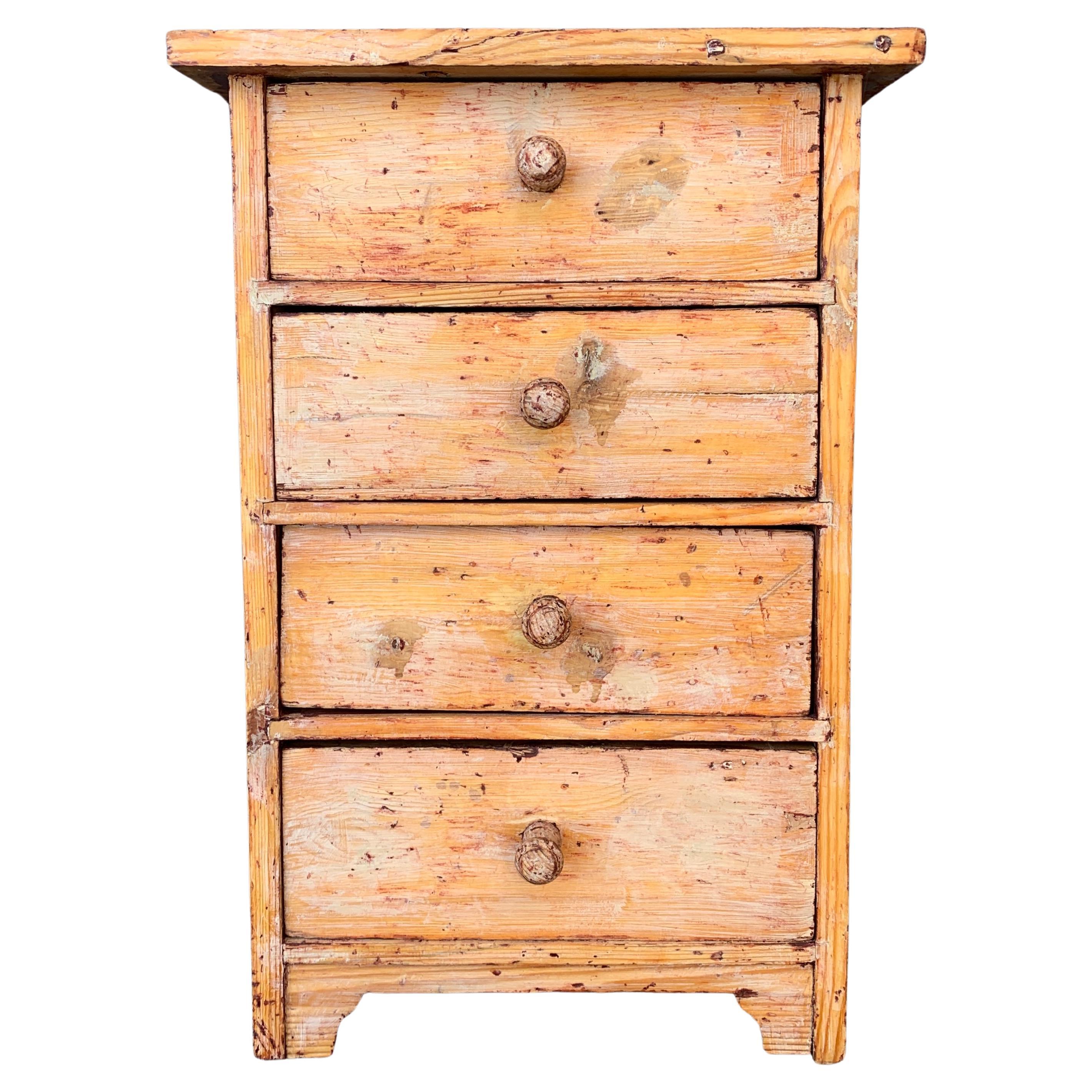 A late 19th century scraped to original patina Swedish nightstand or side table with four drawers and its original wooden handles. From the Folk Art Scandinavian culture called 