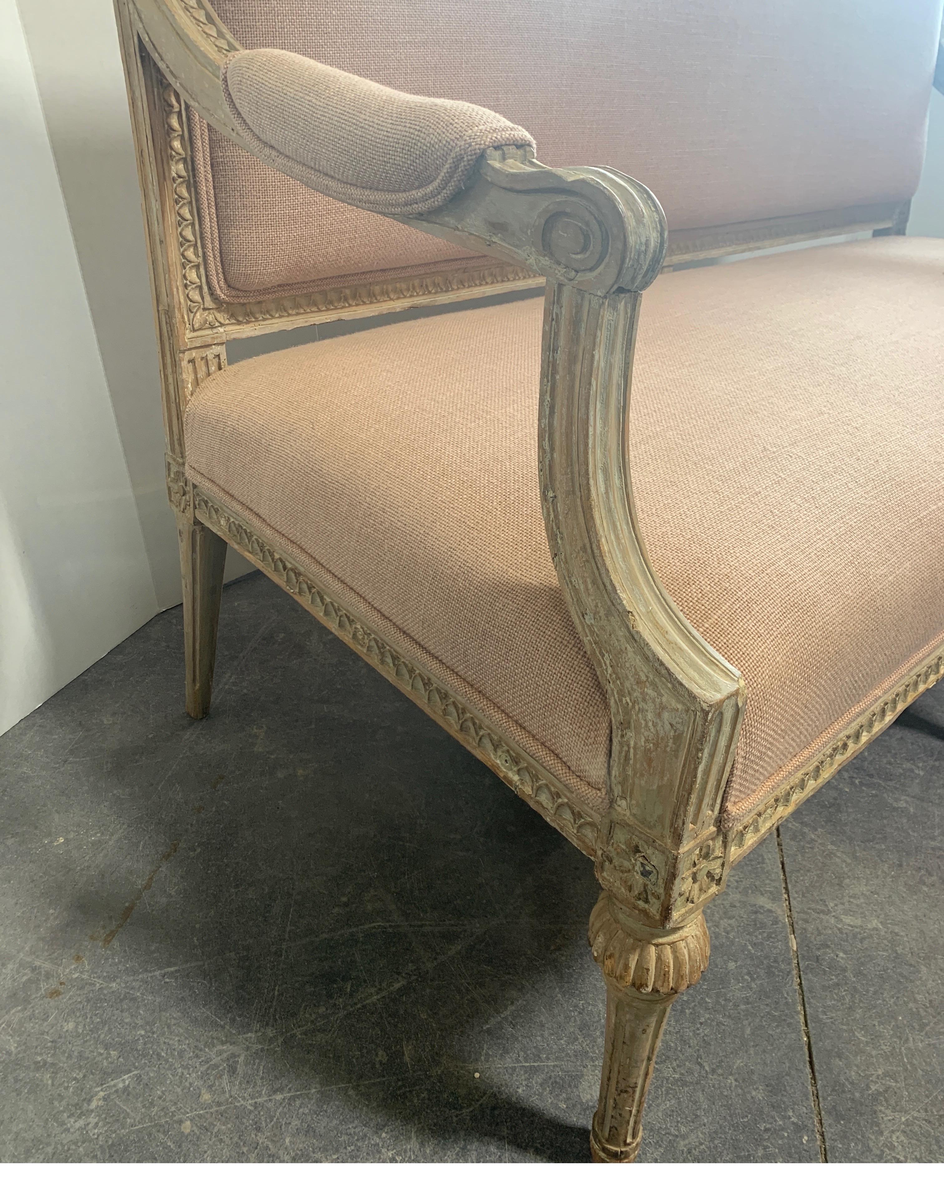 Beautiful faint pale creamy light green painted and scraped Swedish sofa with new blush pink upholstery.
Measures: 57.25 W x 26 D x 37.5 T x 17 T seat.