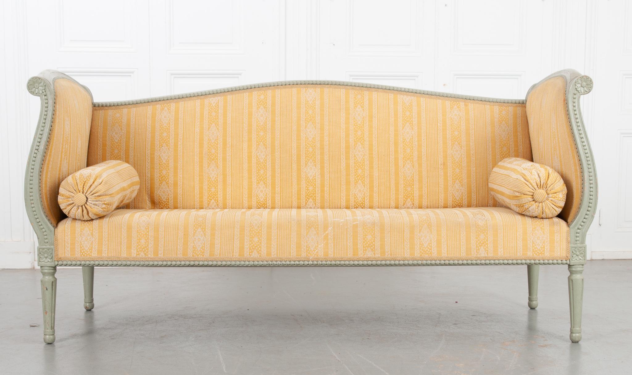 A vibrant upholstered Louis XVI style settee from Sweden, circa 1840. The green-ish blue paint is original to the frame, worn in few spots adding to the overall antique charm. The high back and shaped sides are covered with yellow and white striped