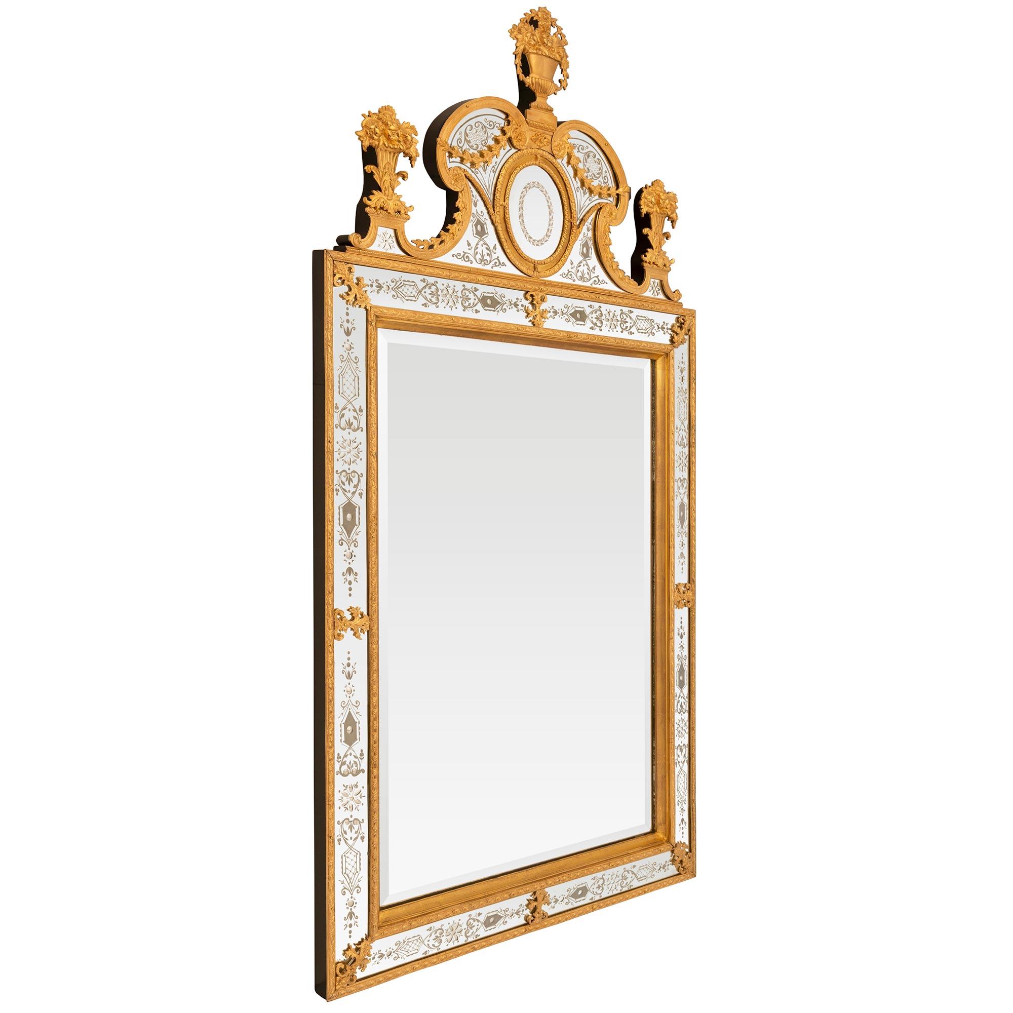 A sensational and high quality Swedish early 19th century Neo-Classical st. etched mirror plate, Giltwood and Ormolu mirror. The original double frame vertical beveled mirror plate is framed within a concave Giltwood frame and an egg and dart Ormolu