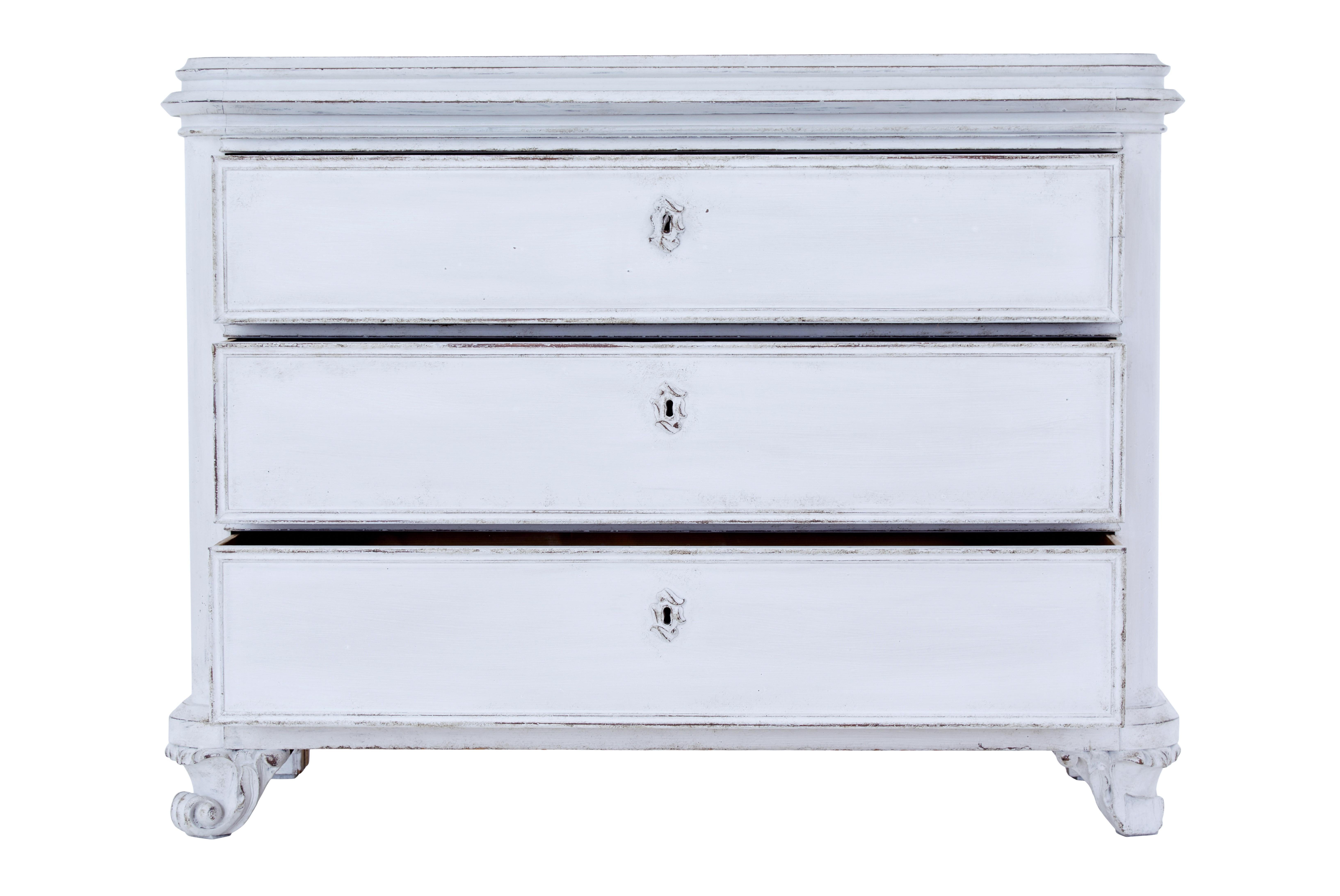 19th century painted chest of drawers circa 1870.

Substantial baroque revival Swedish chest of drawers. Presented in later paint which is best described as a very light grey or a dirty white.

Plain top with moulded edge, below which are 3