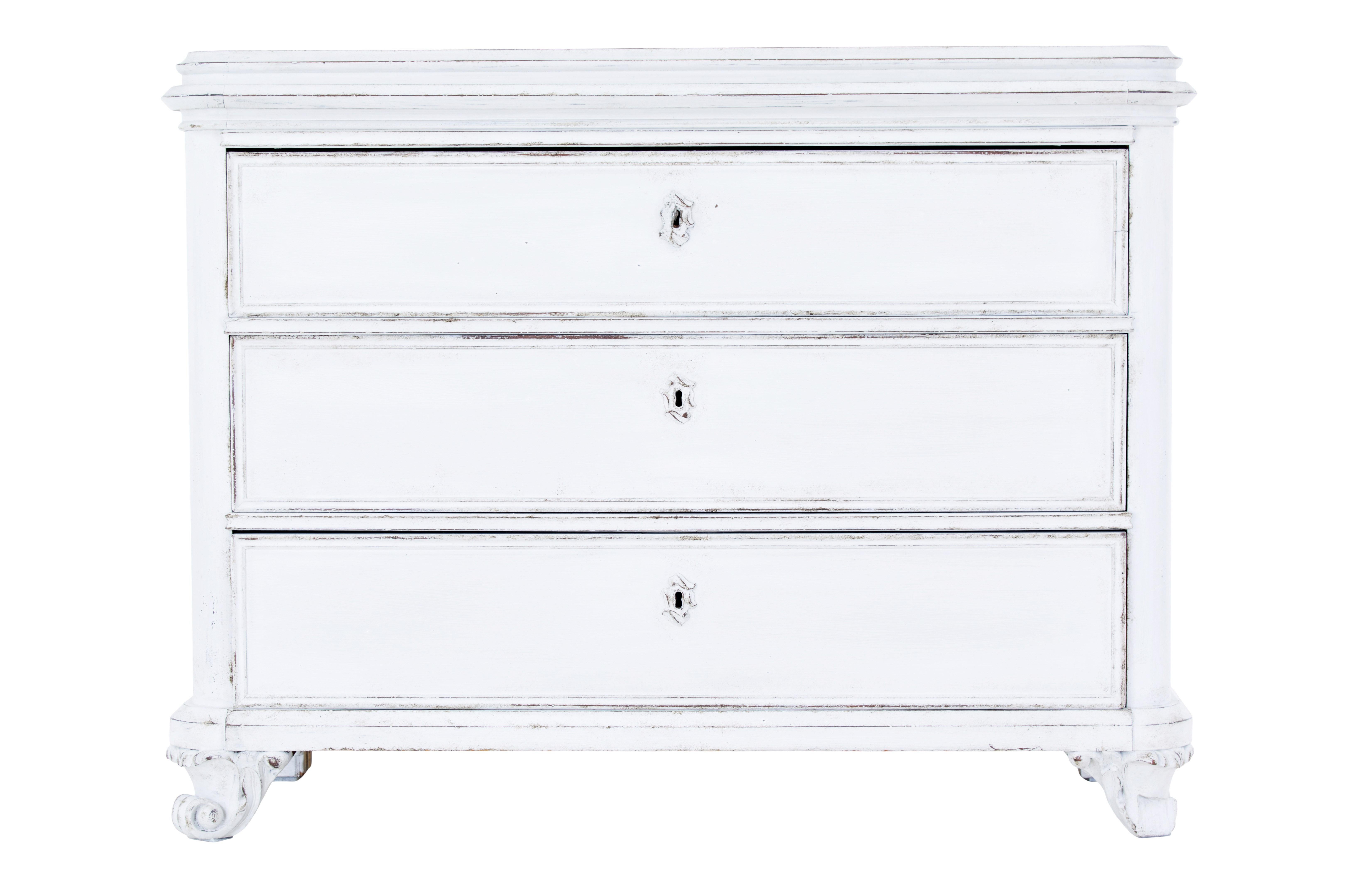 19th century painted chest of drawers circa 1870.

Substantial baroque revival Swedish chest of drawers.  Presented in later paint which is best described as a very light grey or a dirty white.

Plain top with moulded edge, below which are 3 drawers