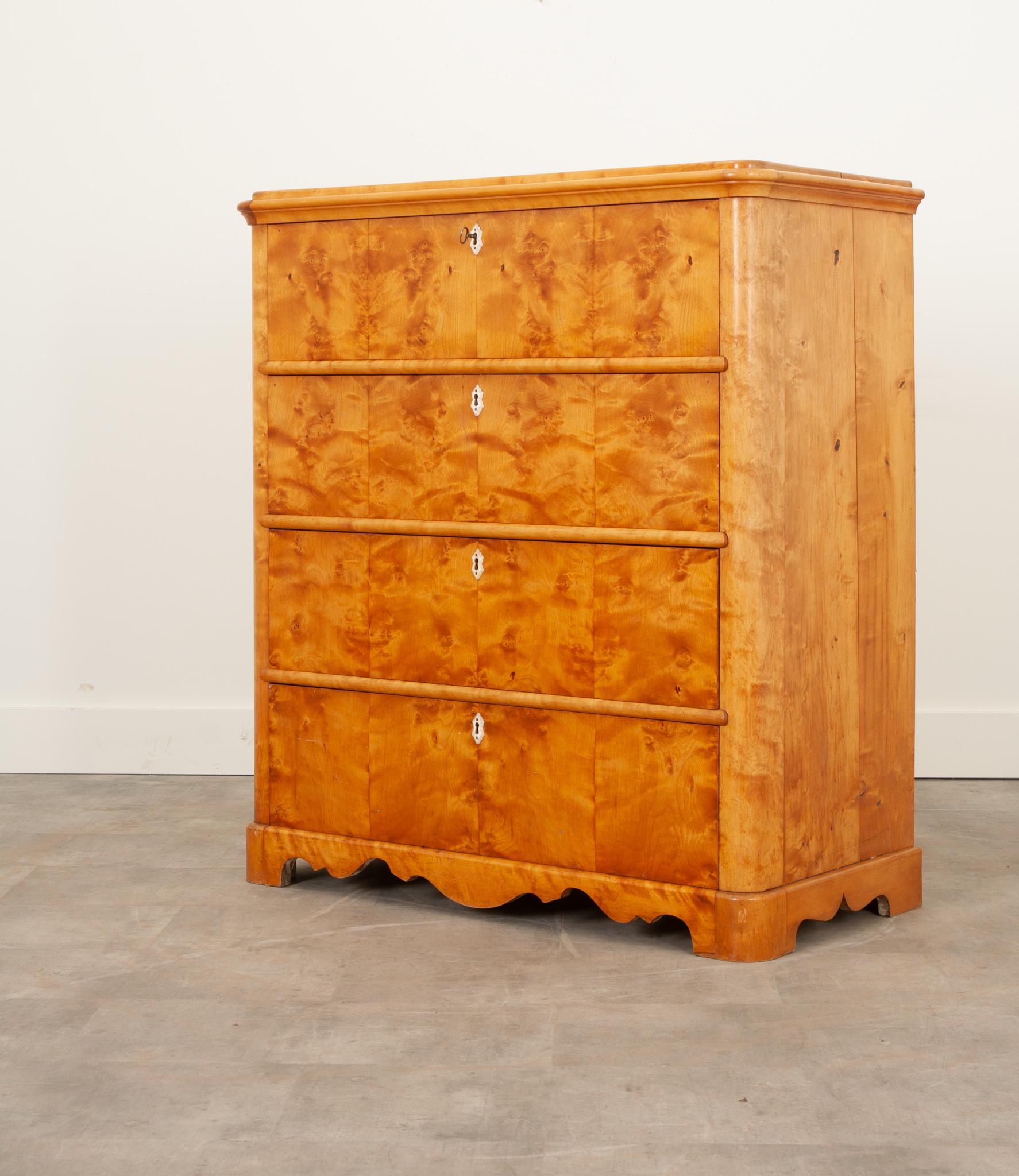 This stunning chest of drawers from the 1800’s Sweden is a showstopper in any space. Crafted from gorgeous bookmatched satinwood, each drawer front features a detailed escutcheon plate carved from bone. The top drawer houses four smaller drawers