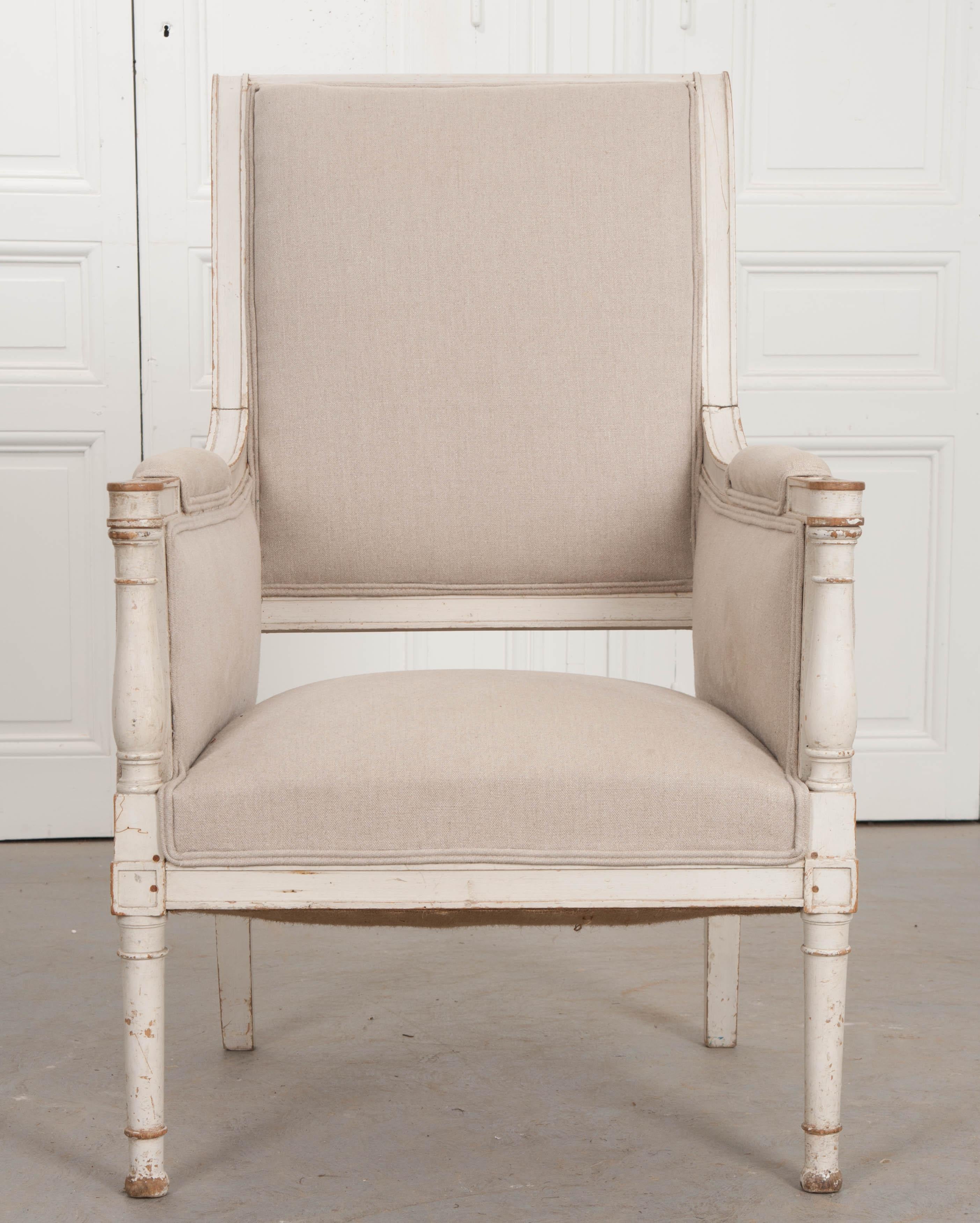 A newly upholstered 19th century Swedish armchair with painted frame. Borrowing elements of both Louis XVI and Empirically styled French furniture, this Swedish Gustavian armchair combines elegance and comfort like few can. The chair is covered in a