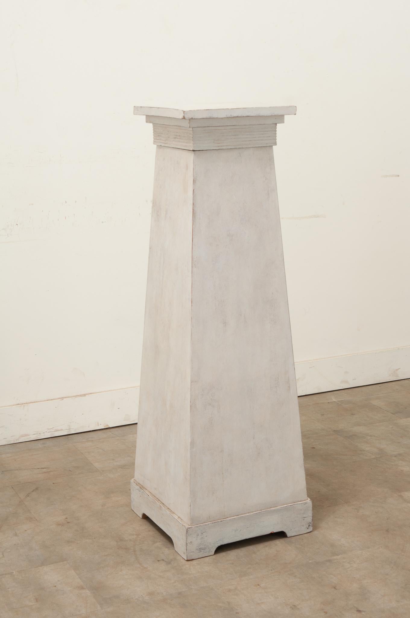 A stately vintage painted column from Sweden. This column has a removable top and a worn painted finish terminating on simple block feet. Perfect for housing a statue or plant in your interior. Be sure to view the detailed images for the current
