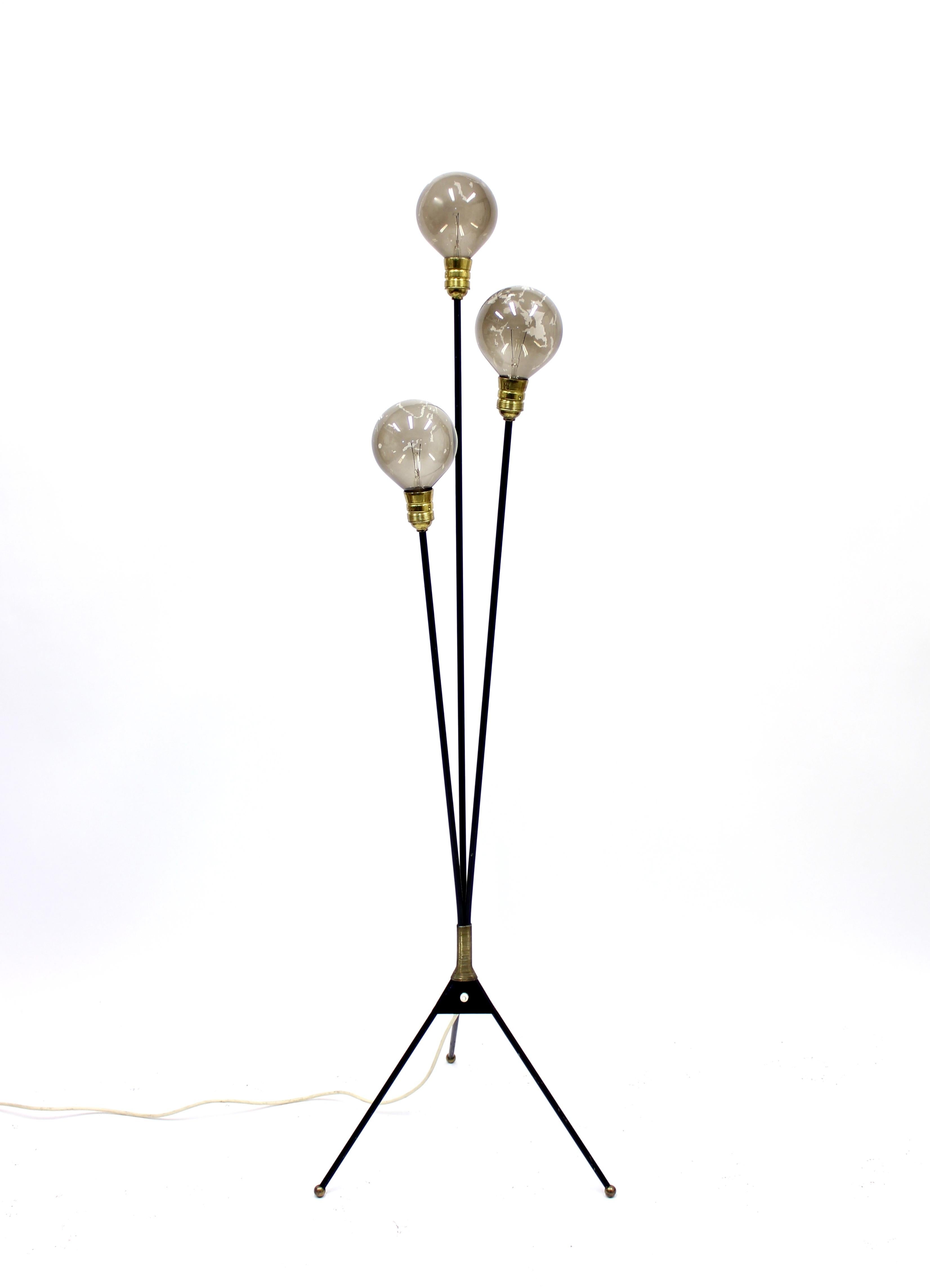 Swedish 3-light floor lamp on a tripod base with ball feet. Brass detail above the base. Ware consistent with age and use.
