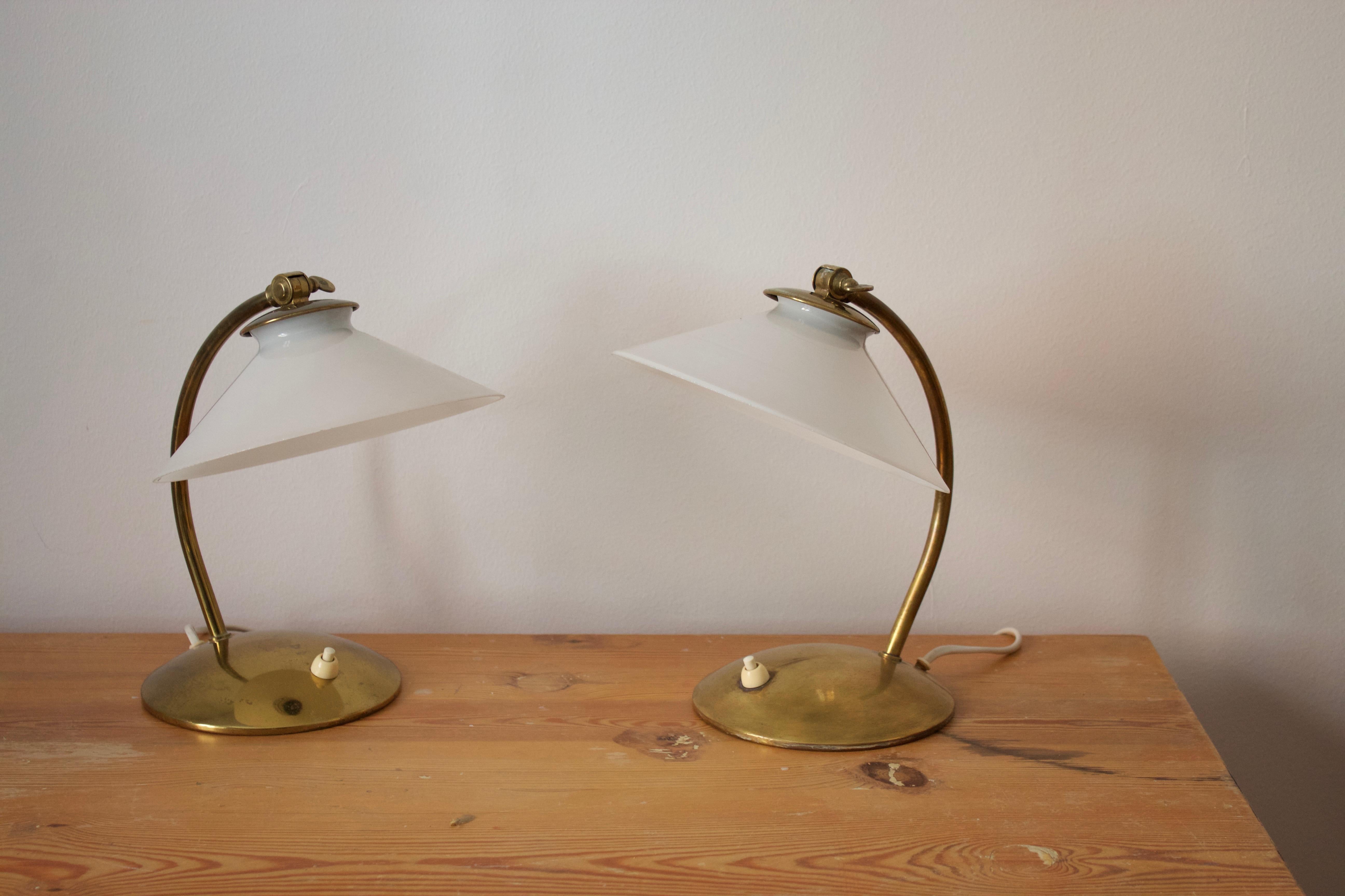 A pair of small table lamps / desk lights. With their original milk glass lampshades. Designed and produced in Sweden, 1940s.