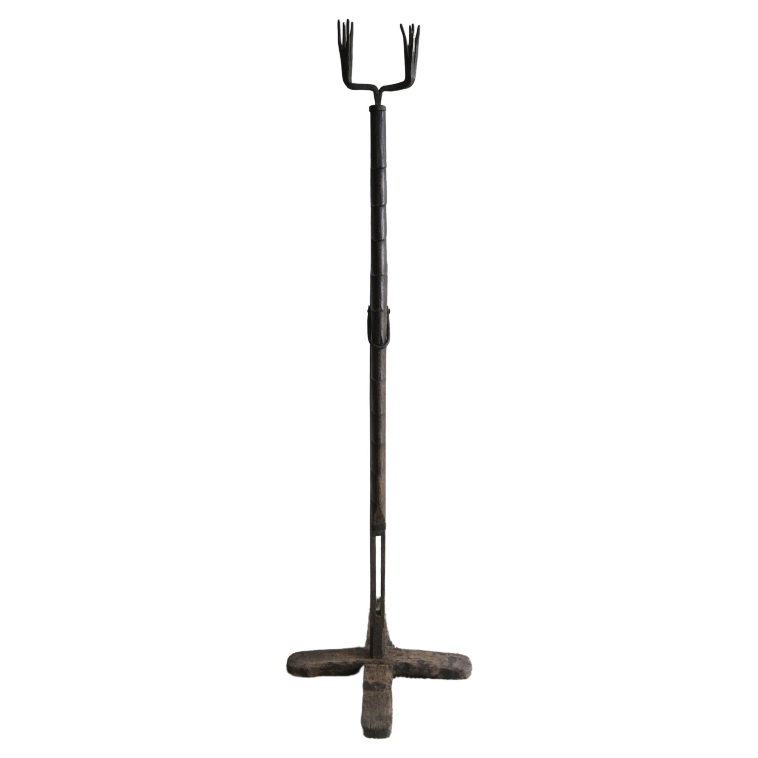 Swedish adjustable Floor Candlestick holder, also called 'Lyskärring'.
Circa 1780-1830.

The patina is really dark and has an almost mahogany feel to it.

This was originally not intended for candles; it was for birch sticks to be burnt and wedged
