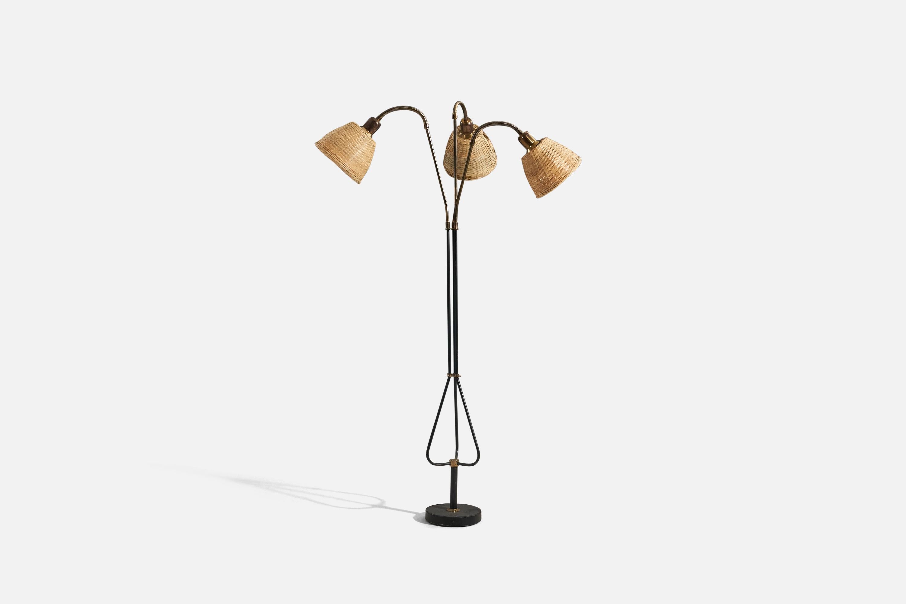 A brass, black-lacquered metal and rattan, adjustable floor lamp designed and produced in Sweden, 1950s.

Variable dimensions, measured as illustrated in the first image.
Sold with Lampshade(s). 
Stated dimensions refer to the Floor Lamp with the