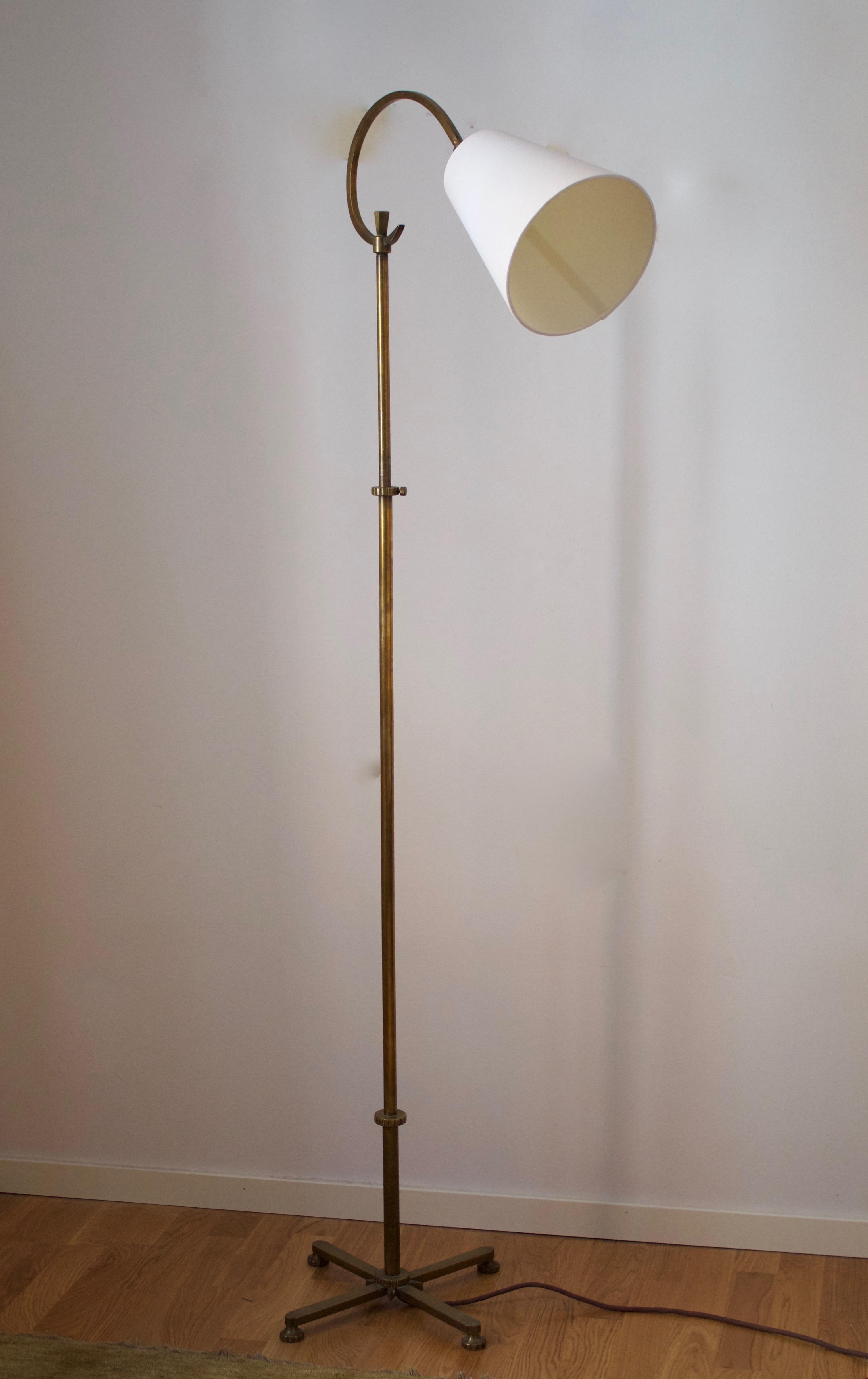 An adjustable floor lamp. Designed and produced in Sweden 1940s. With a brand new lampshade.