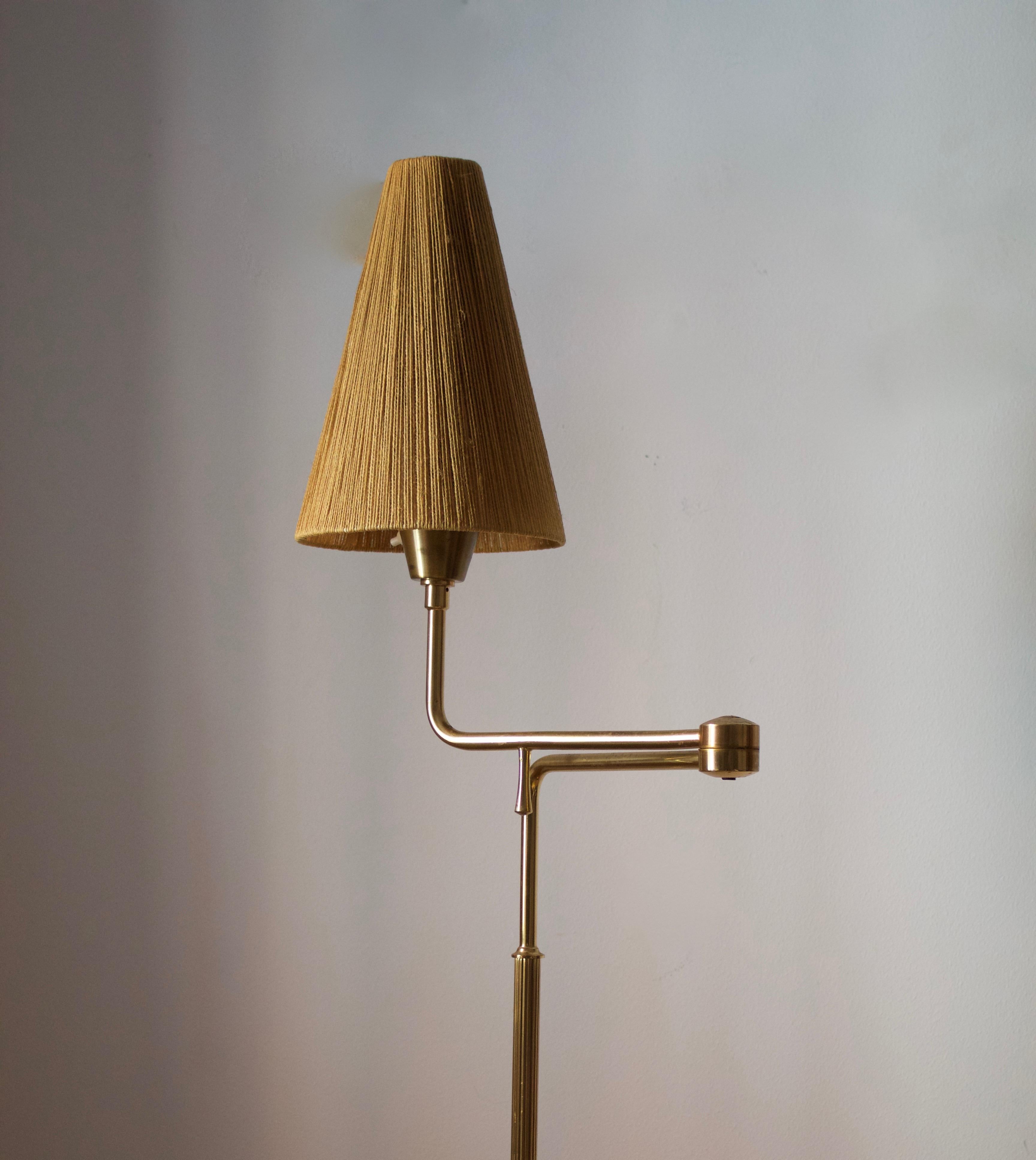 An adjustable floor lamp. Designed and produced in Sweden, c. 1950s-1960s. With a vintage string lampshade.
