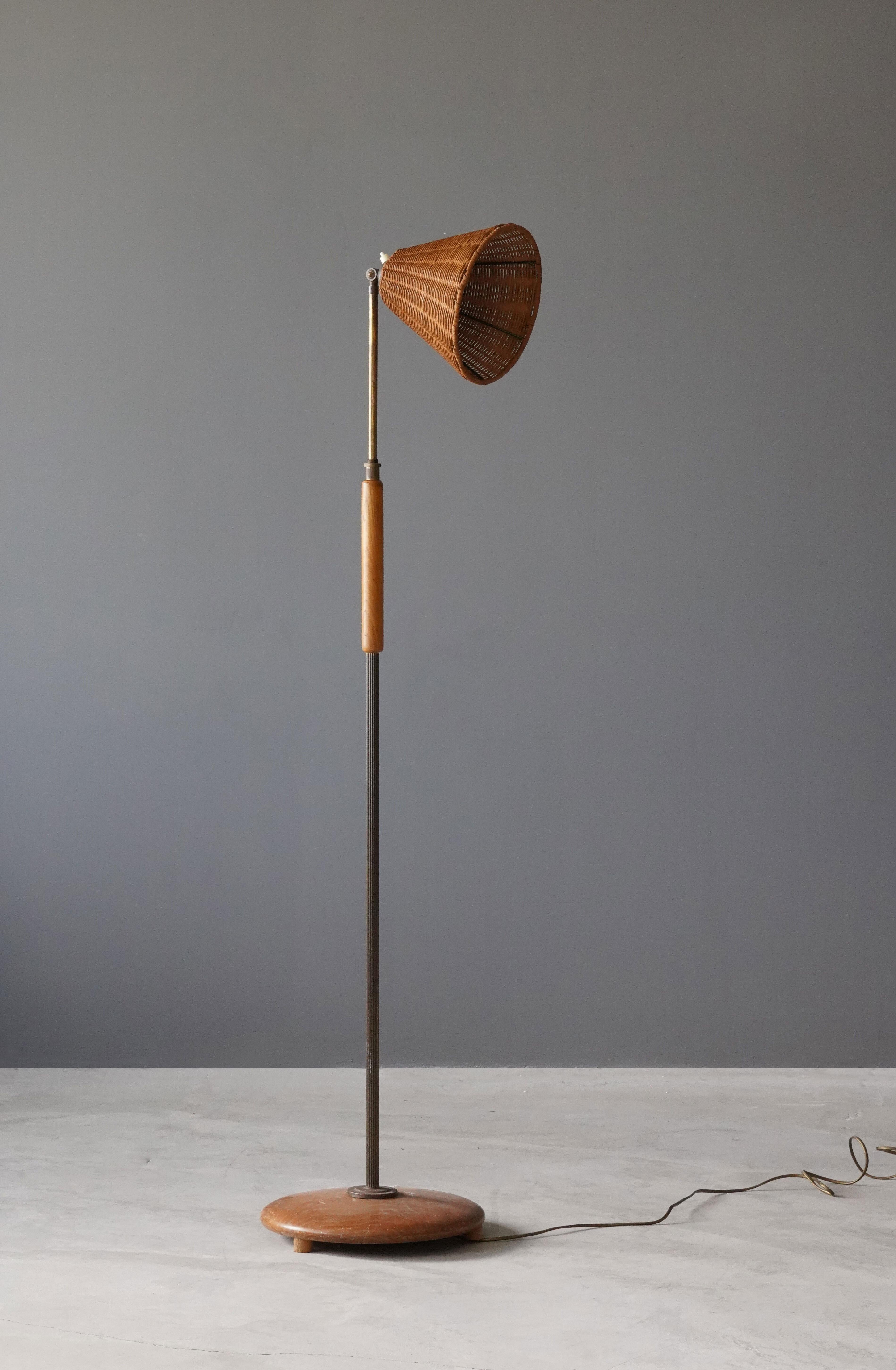 An adjustable floor lamp, designed and produced in Sweden, 1940s. Stained wood and chrome metal. Brand new fabric lampshade with floral motifs.

Organic adjustable arm and rod, height adjustable.. Brass is unpolished and has retained beautiful