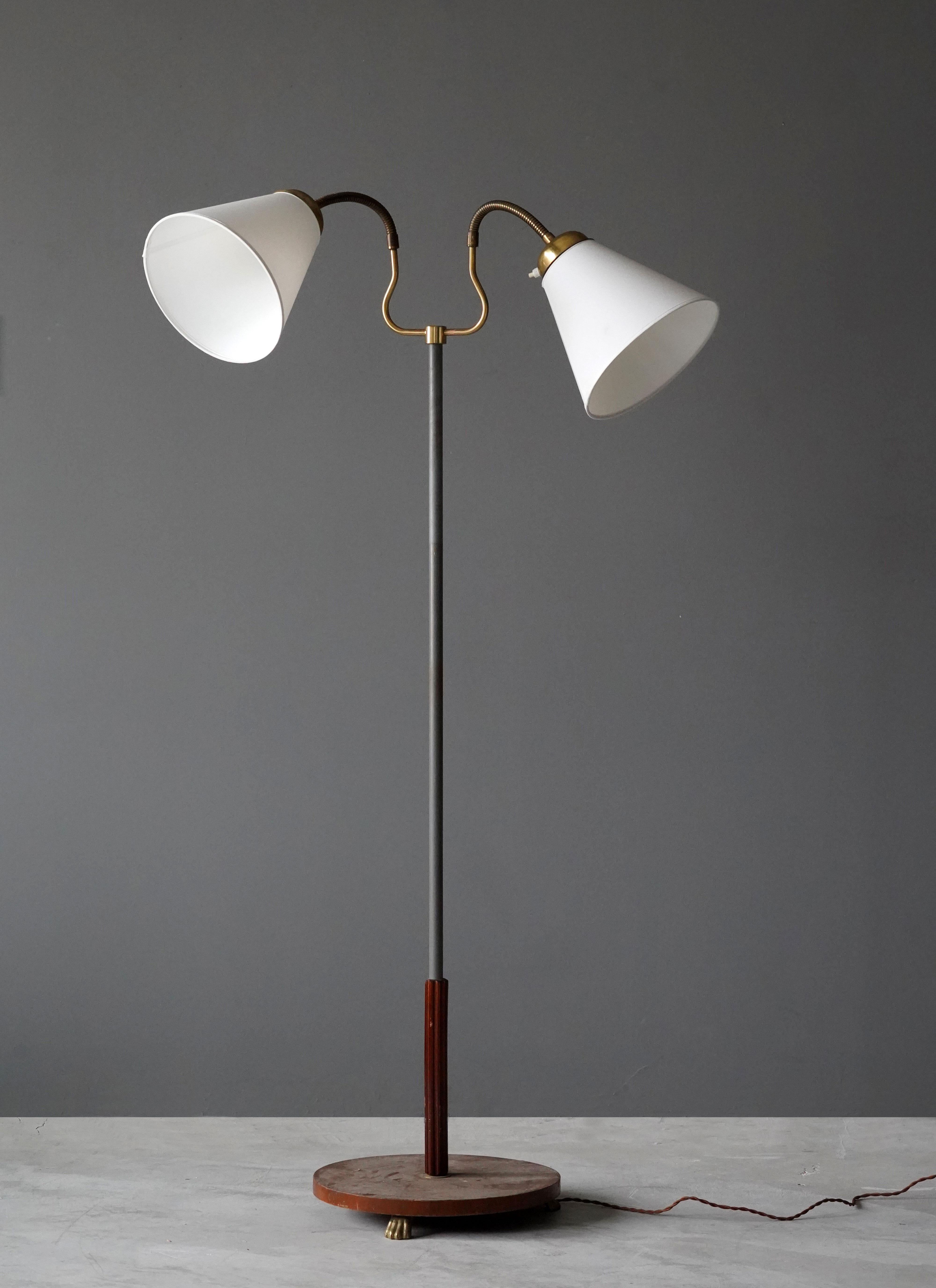 An adjustable two-armed functionalist floor lamp. With adjustable arms. Vintage lampshades. 

Dimensions variable. Stated measurements as illustrated.

Other designers of the period include Josef Frank, Paavo Tynell, Hans Agne Jacobsen, and