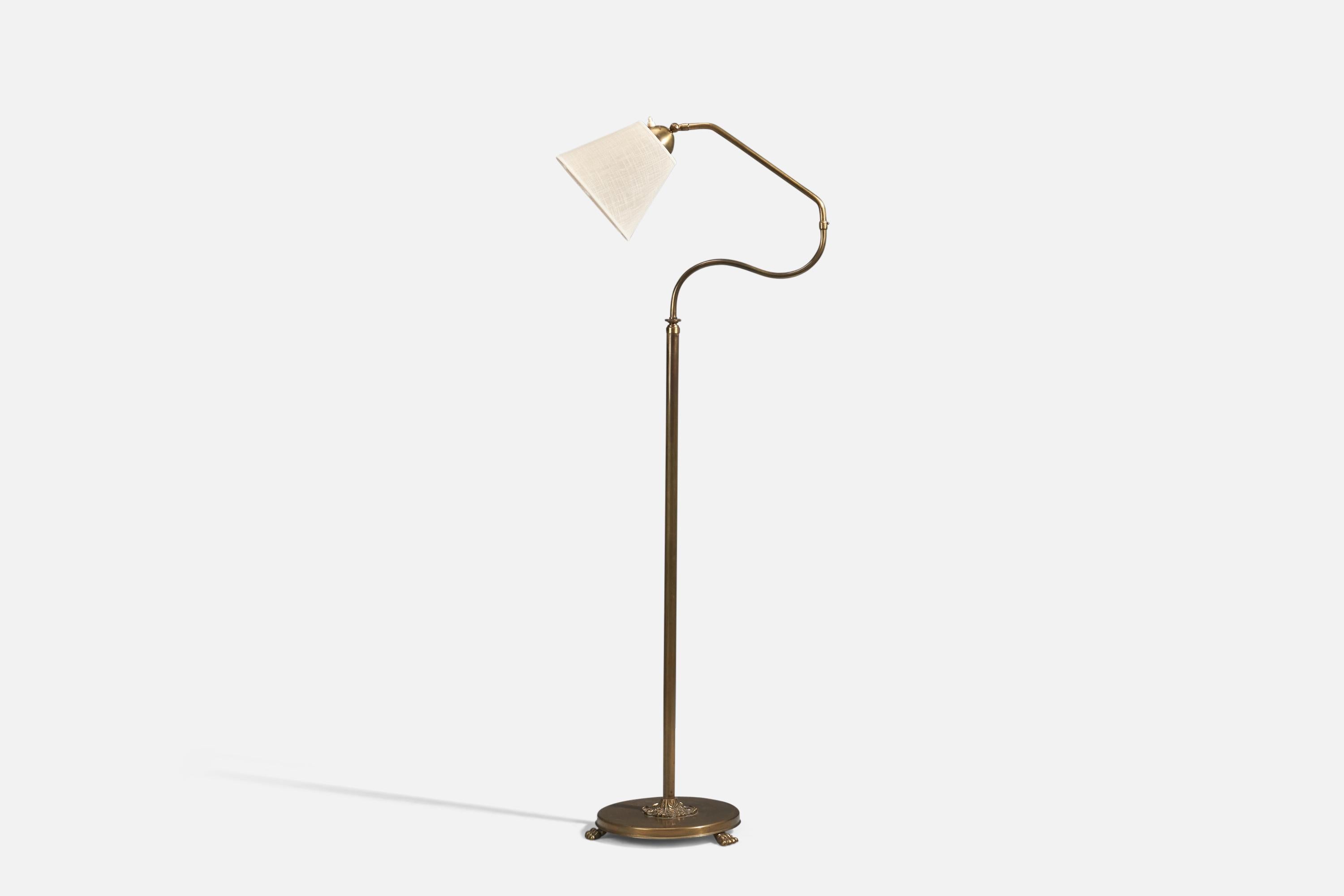 An adjustable brass and fabric floor lamp designed and produced by Swedish Designer, Sweden, 1940s.

Organic adjustable arm and rod, height adjustable. Features ornamentation to the base. Brass is unpolished and has retained beautiful patina.

Wear