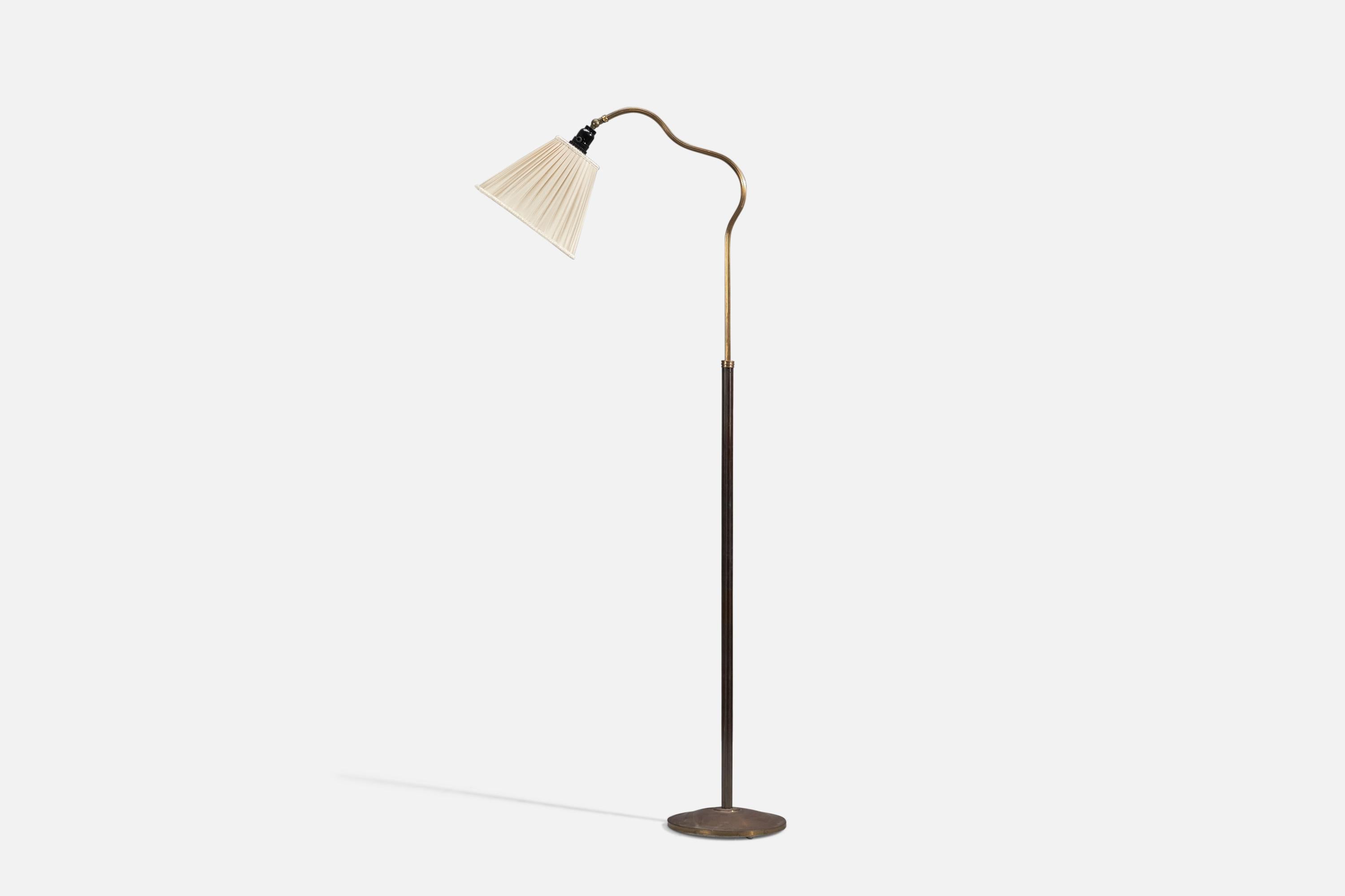 A brass and fabric floor lamp designed and produced by Swedish Designer, Sweden, 1940s. 

Organic adjustable arm and rod with fluted detailing. Features a modern and pure base. Brass is unpolished and has retained beautiful patina.

Wear consistent