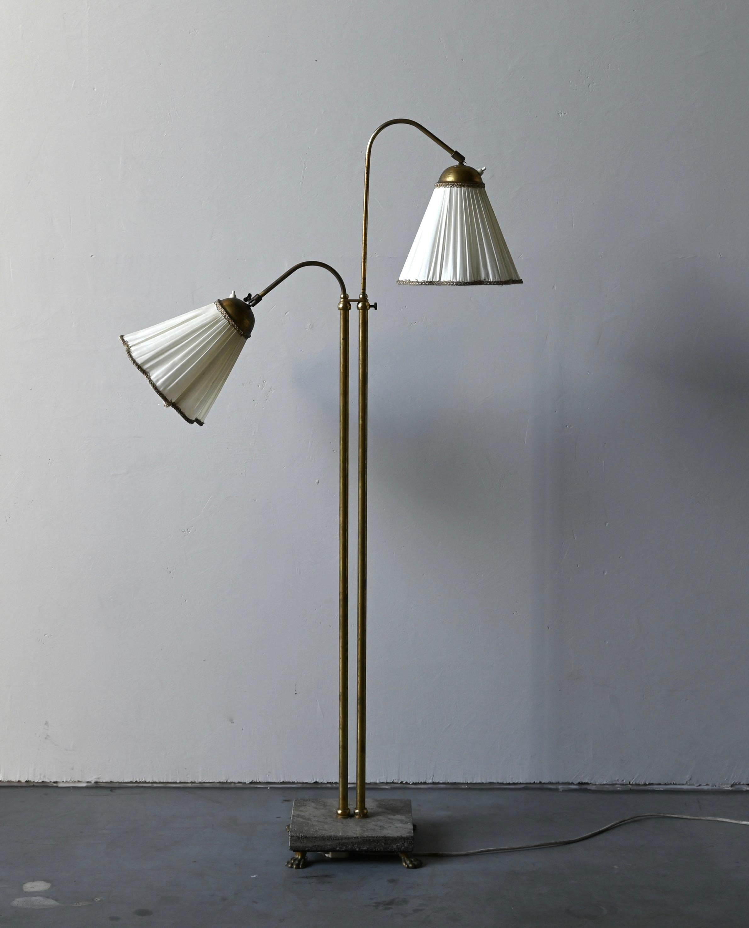 An adjustable floor lamp. Designed and produced in Sweden, 1940s. Brass with heavy marble base. Vintage lampshades.