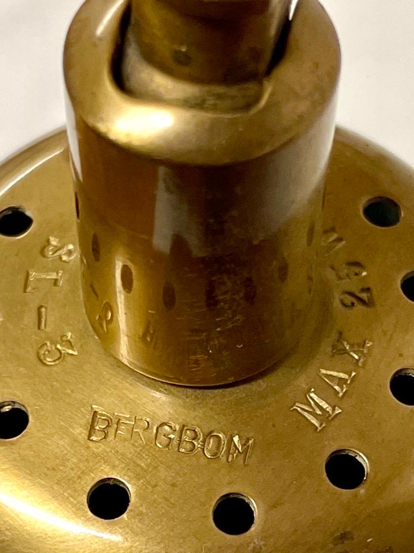 THE PRODUCT
Presented here is the adjustable Swedish wall lamp model SL 3, designed by Alf Svensson for Bergbom & Co in the 1950s.
The lamp features a bell-shaped, perforated brass shade mounted on a gracefully bent brass arm.
The shade tilts