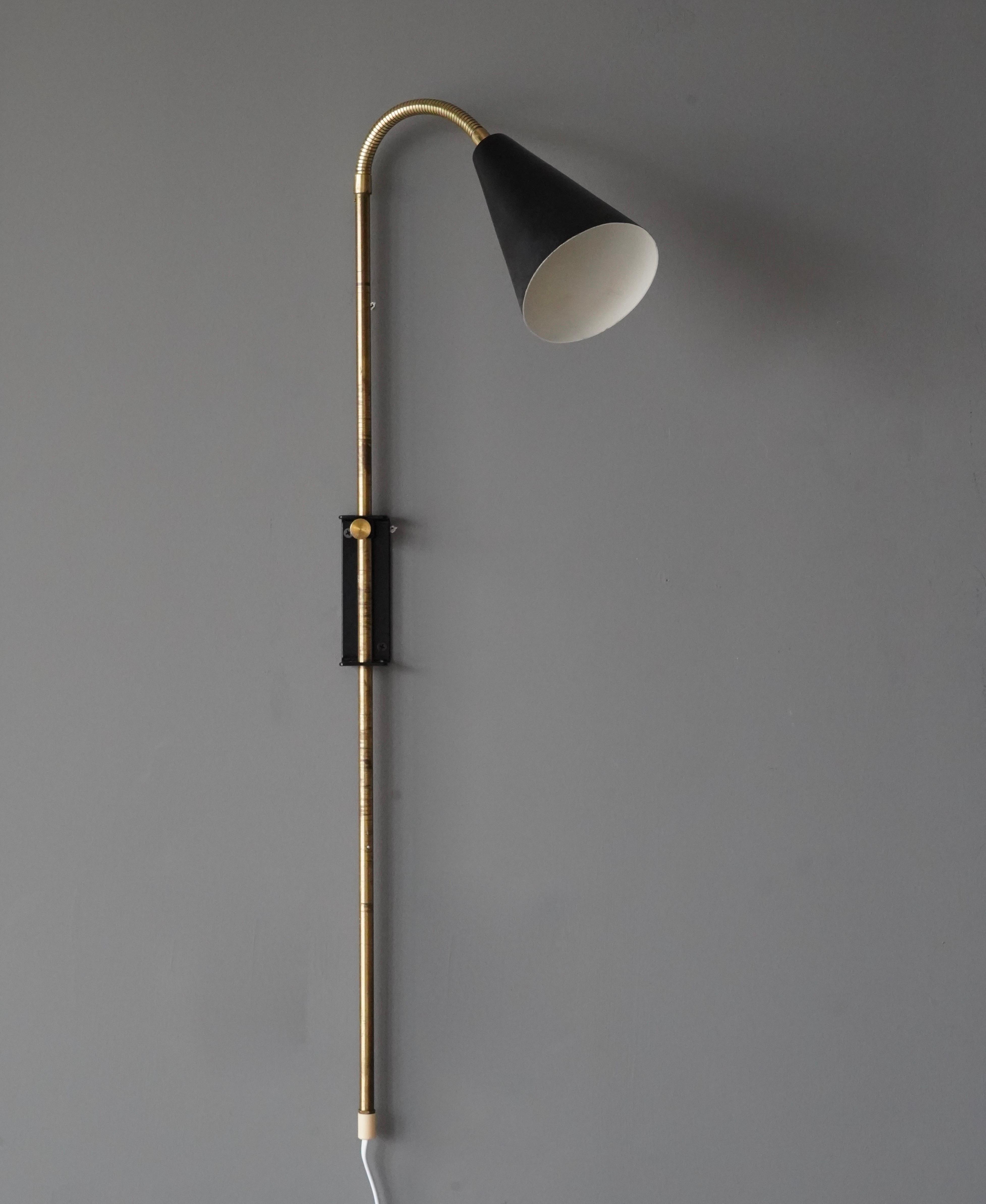 An adjustable functionalist wall light / task light. Designed and produced in Sweden, 1940s-1950s.

Features brass and black-lacquered metal.

Dimensions listed are as its illustrated position.