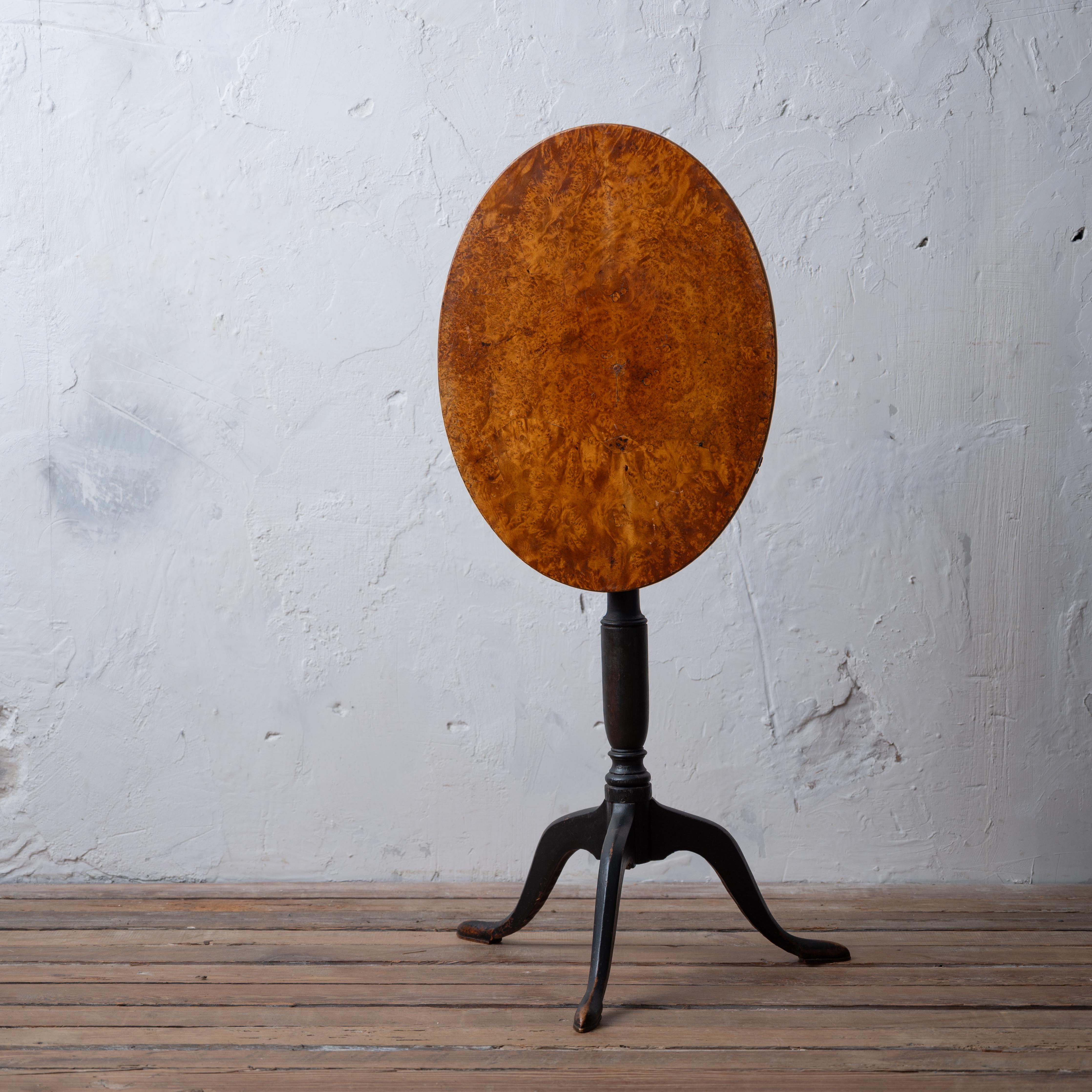 A Swedish alder root burl tilt-top wine table with black painted tripod base, circa 1860.

20 ½ inches wide by 15 ¼ inches deep by 27 ½ inches tall; tilted 39 inches tall


