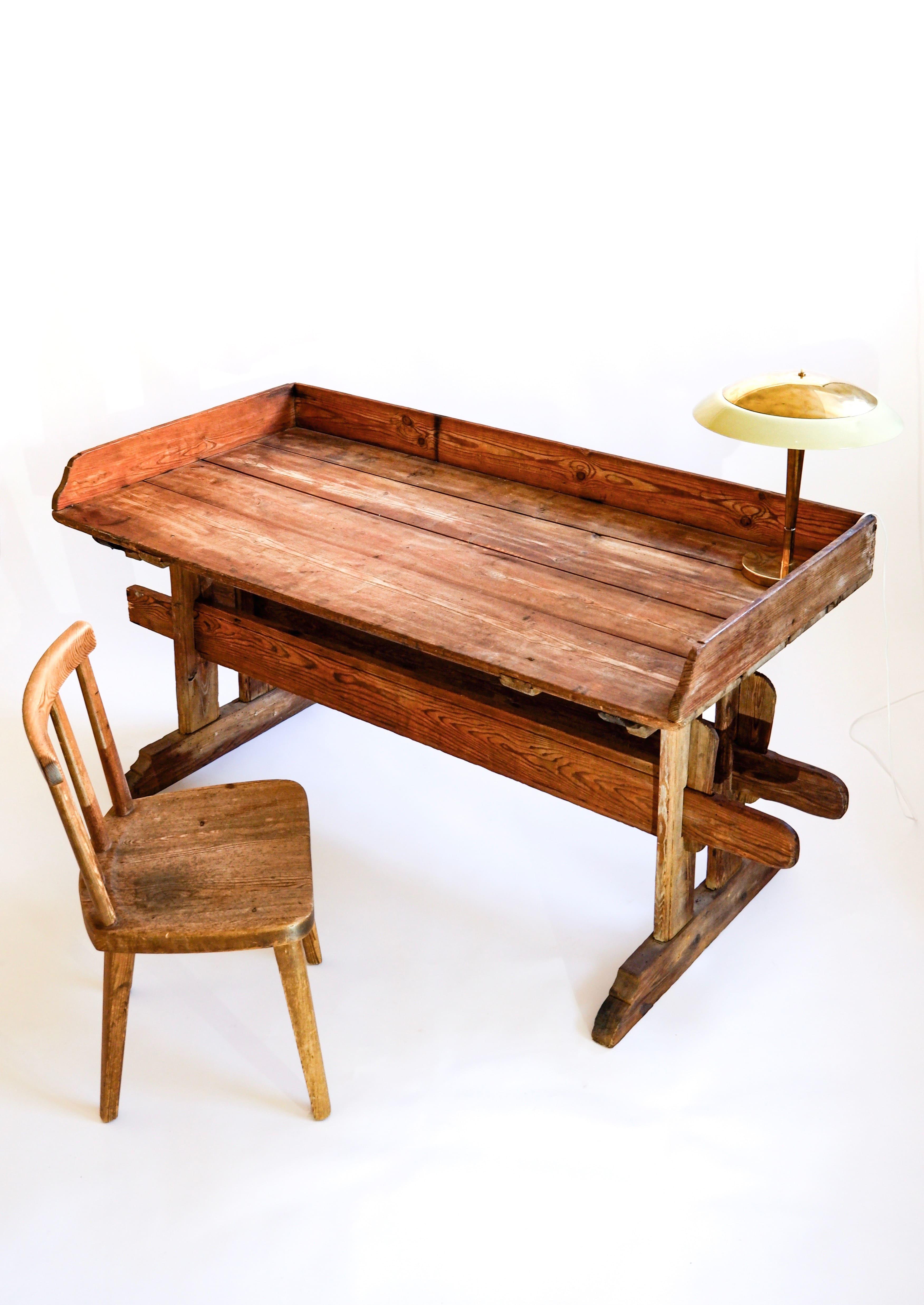 Impressive Folkart swedish table/desk made in solid pine in the late XIX century. The table is composed by two wood crosses hold by four wood keys in total. The top of the consol table has an amazing patina. Overhall the table has no structural