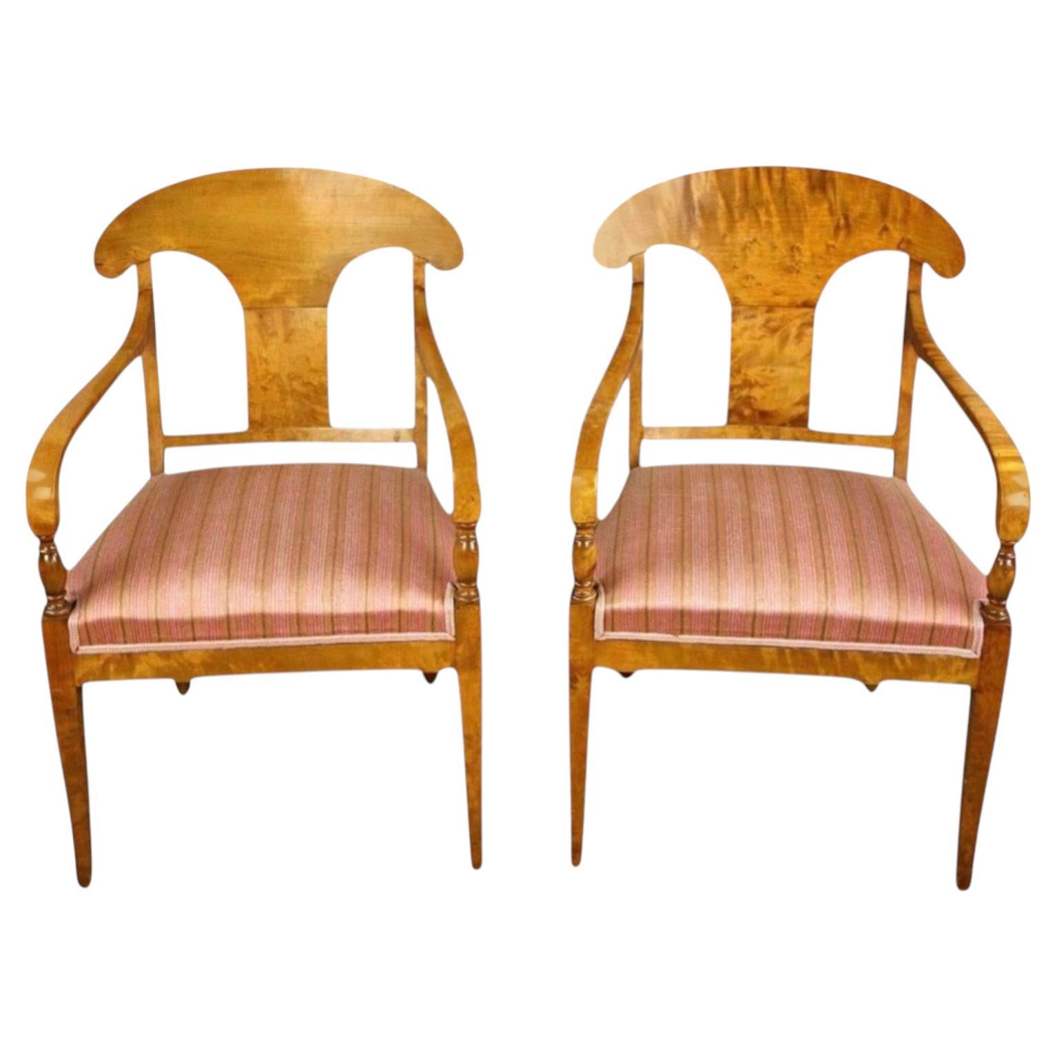 What is a dining chair with arms called?