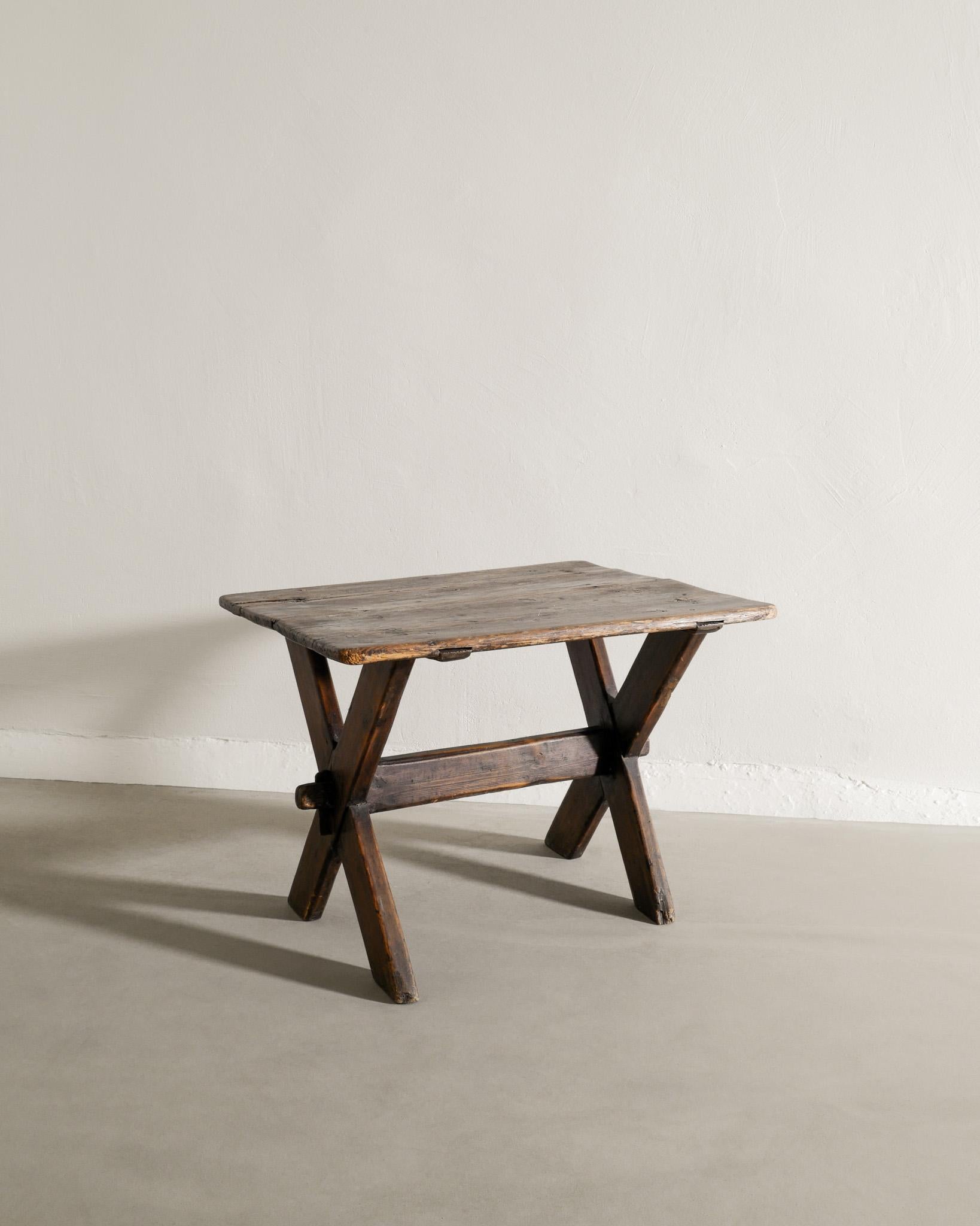Swedish Antique Dark Wooden Pine Table with Crossed Legs Produced Late, 1800s  In Good Condition In Stockholm, SE