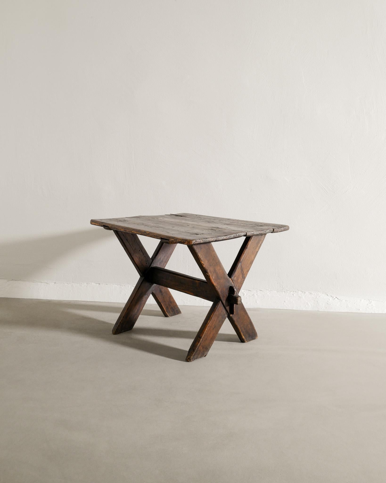 Late 19th Century Swedish Antique Dark Wooden Pine Table with Crossed Legs Produced Late, 1800s 