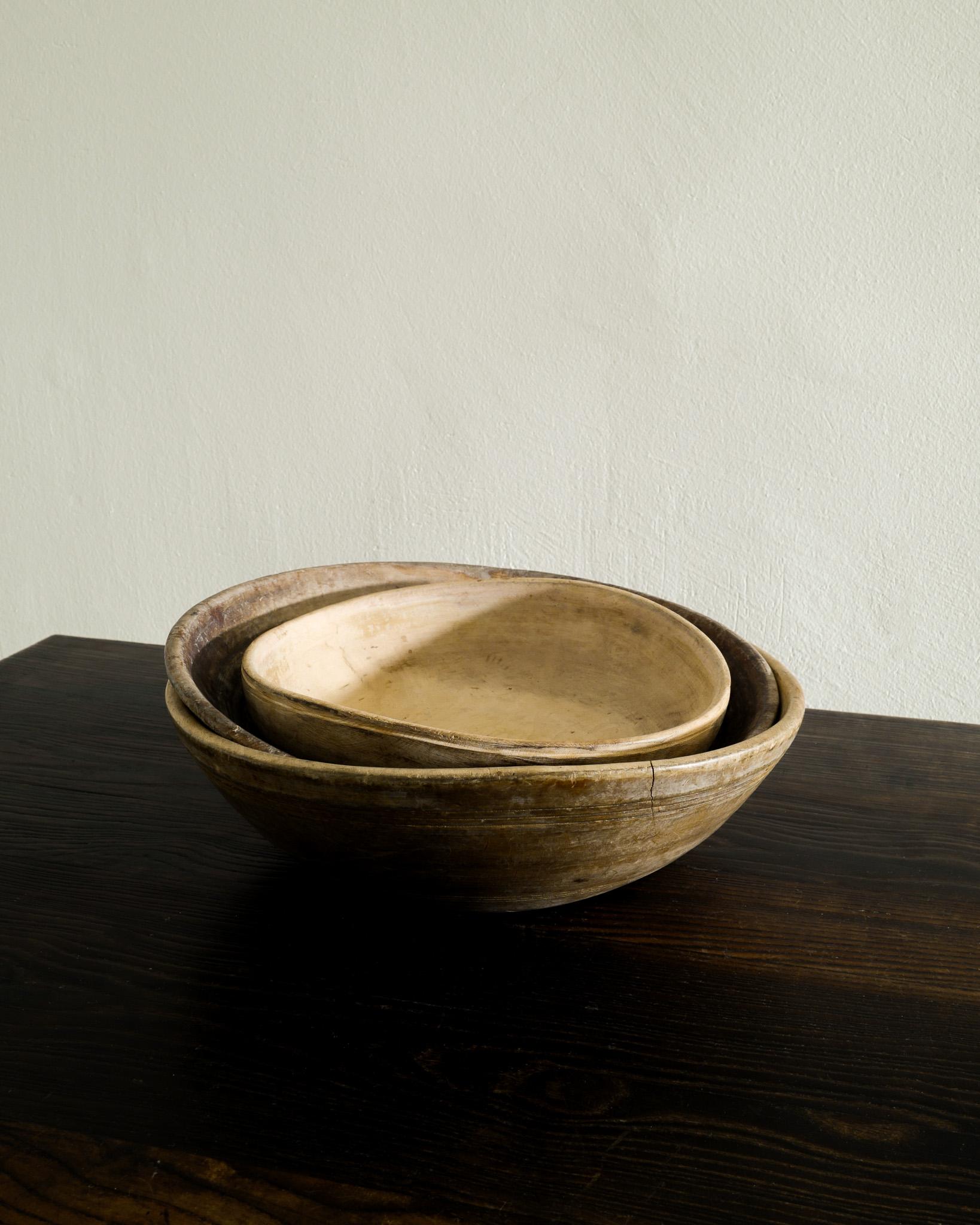 Rare set of three decorative antique wooden bowls produced in Sweden late 1800s. In good original condition with patina from age and use. 

Dimensions: 
Small: H: 7 cm Diameter: 25 cm 
Medium: H: 7 cm Diameter: 32 cm 
Large: H: 10 cm Diameter: 35 cm 