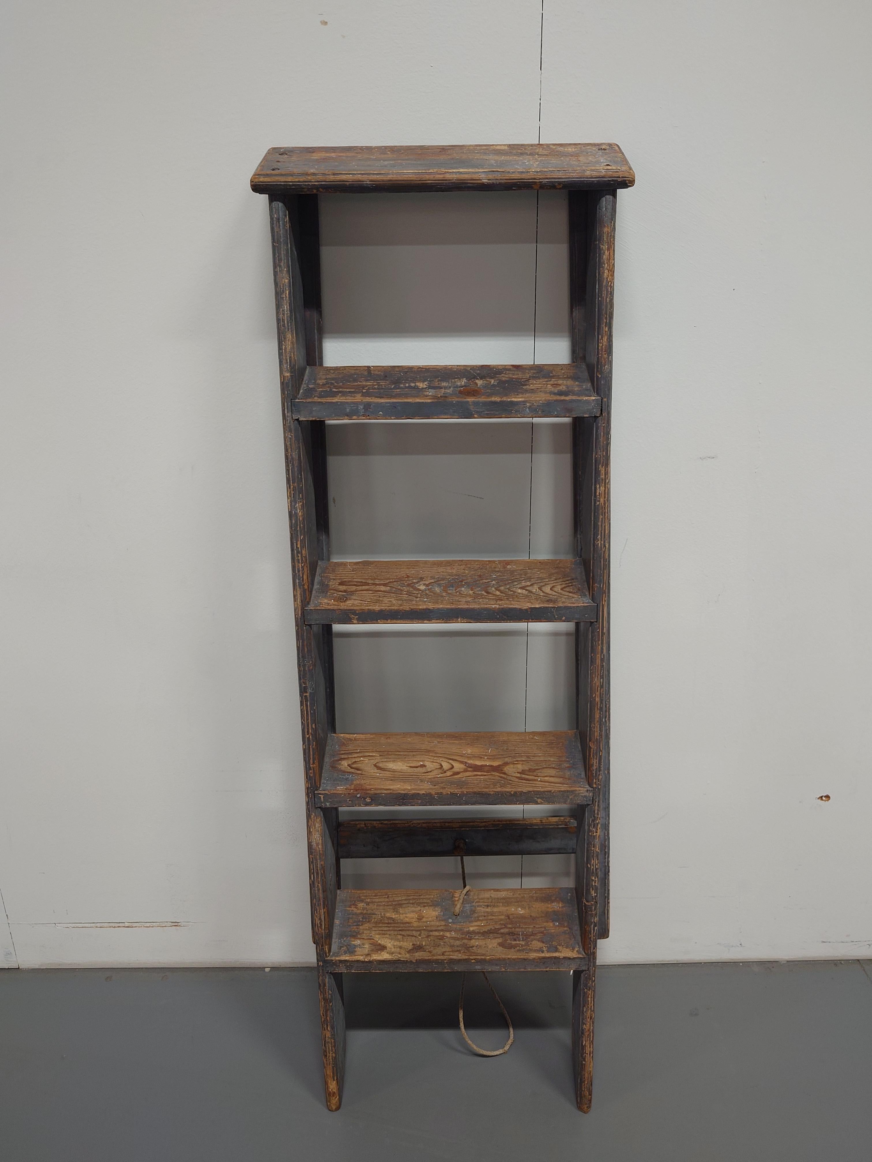 Handsome late 19th century Swedish country folding  ladder.  The ladder has beautiful gray original paint. Featuring a handcrafted design with five rungs or steps .Useful both  inside & outside.
Stable in construction.
Made in painted pine.
