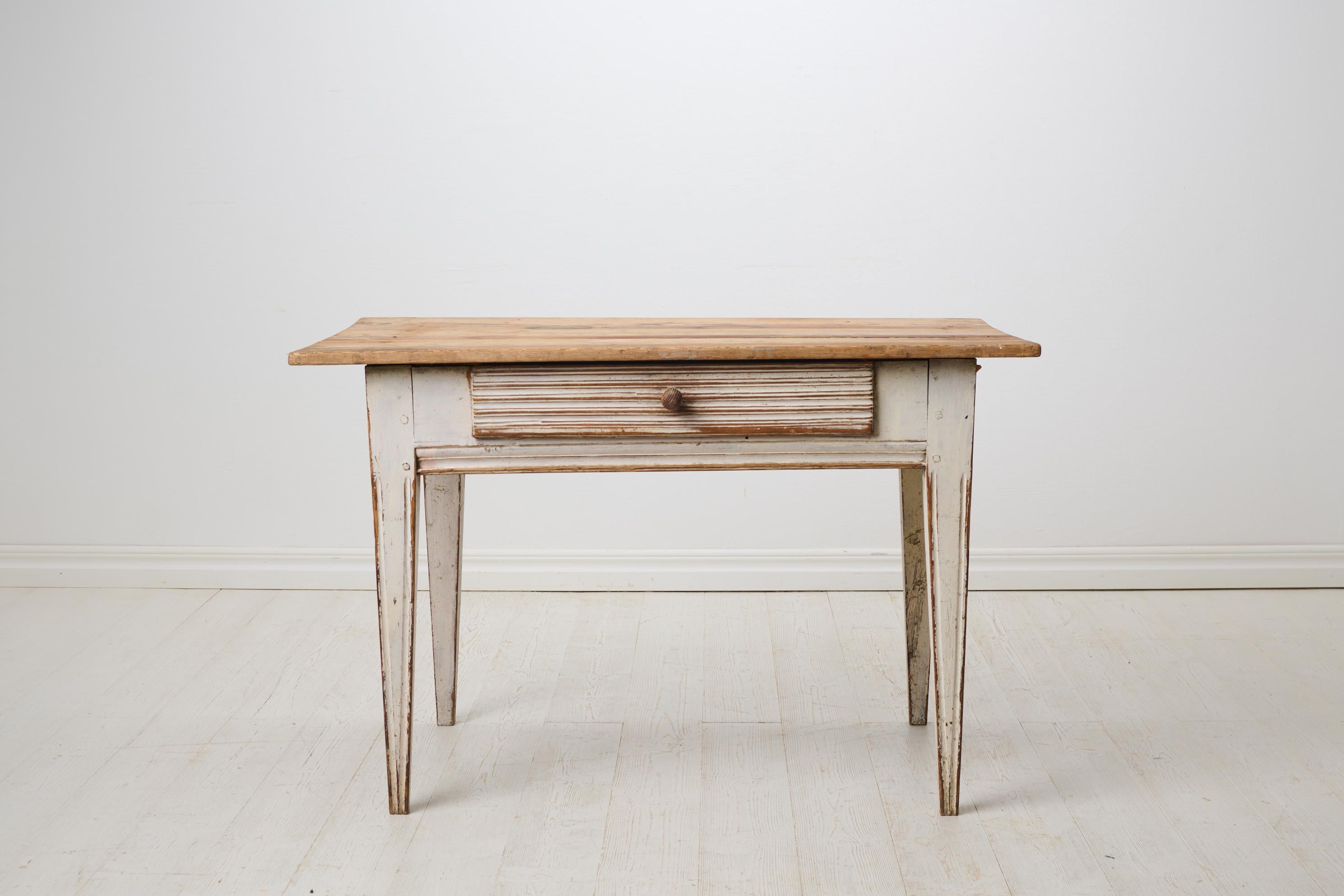 Table suédoise ancienne et authentique. Cette table de maison de campagne gustavienne a été fabriquée entre 1820 et 1830 dans le nord de la Suède, dans la région de Hälsingland. Il a une forme classique gustavienne avec des pieds droits effilés avec