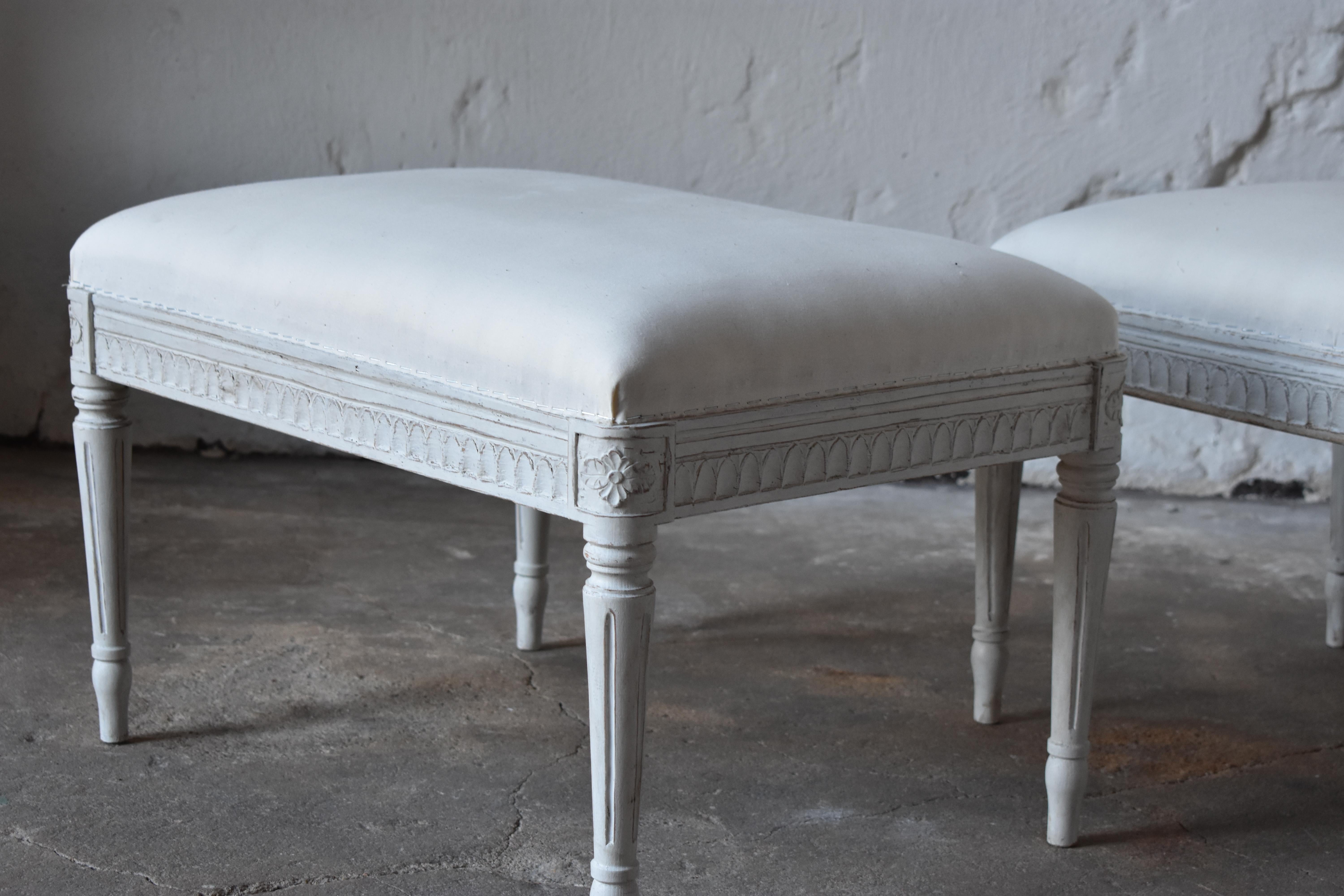 Swedish Antique Gustavian Taburettes, circa 1800s
Original upholstery with new textile
tapered legs with carved flowers on top of each leg
painted in a white-greyish color and distressed finish.