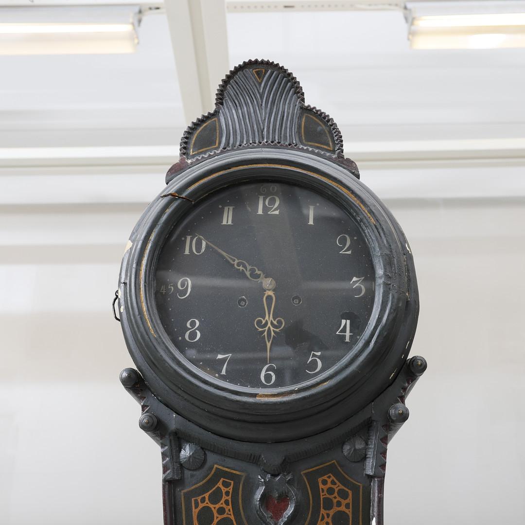 decorative C. 1815 antique Swedish mora clock with fine hand painted folk art detail with a stunning bird on the body and 1815 on the inside of the door , initials inside the body and carved detailing on the hood in a deep blue black paint finish