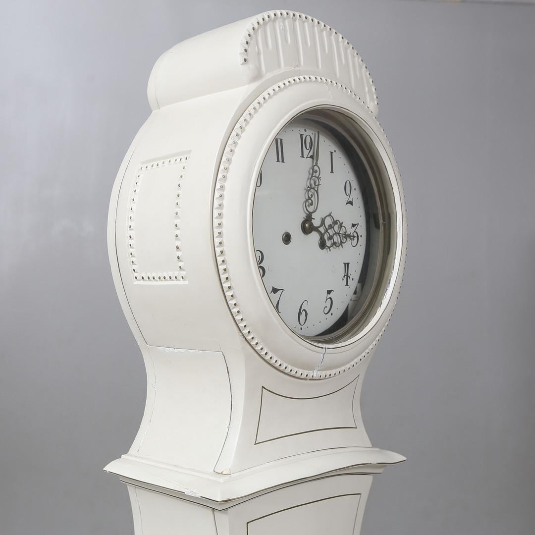 203cm  v rare early 1800s antique Swedish mora clock with finely carved detail on the body and hood and detailed face  in a later white painted finish. 

Measures: 203cm.

The clock body is distressed as befits its age and has the usual wood