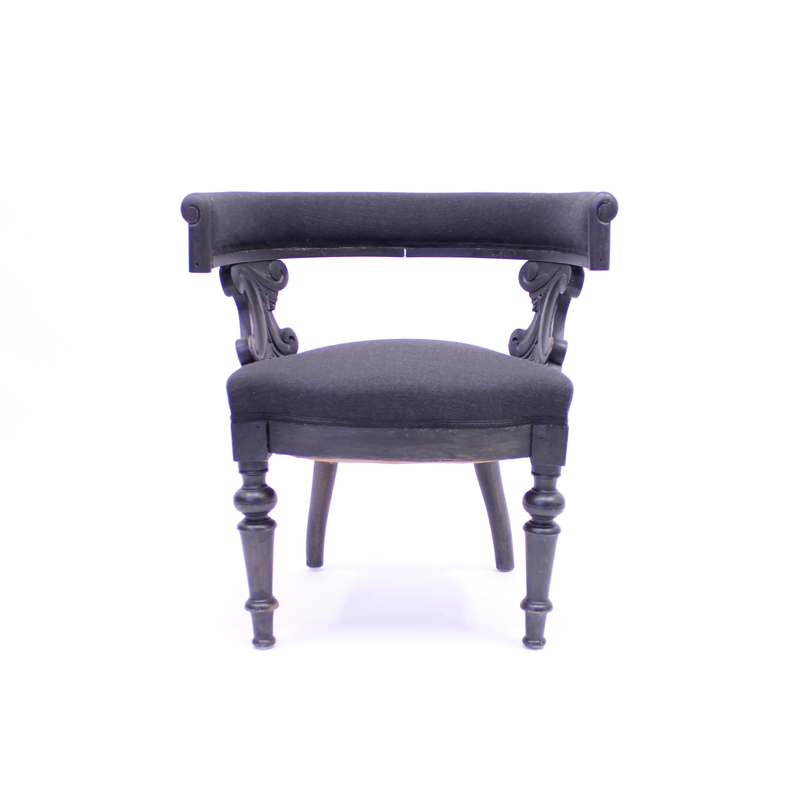 Swedish antique oak Klismos chair from the late 19the century. Very broad and robust in appearance. Side panels with carved ornaments and lathed front legs. The black paint might not be original but was done quite a long time ago and suits the model