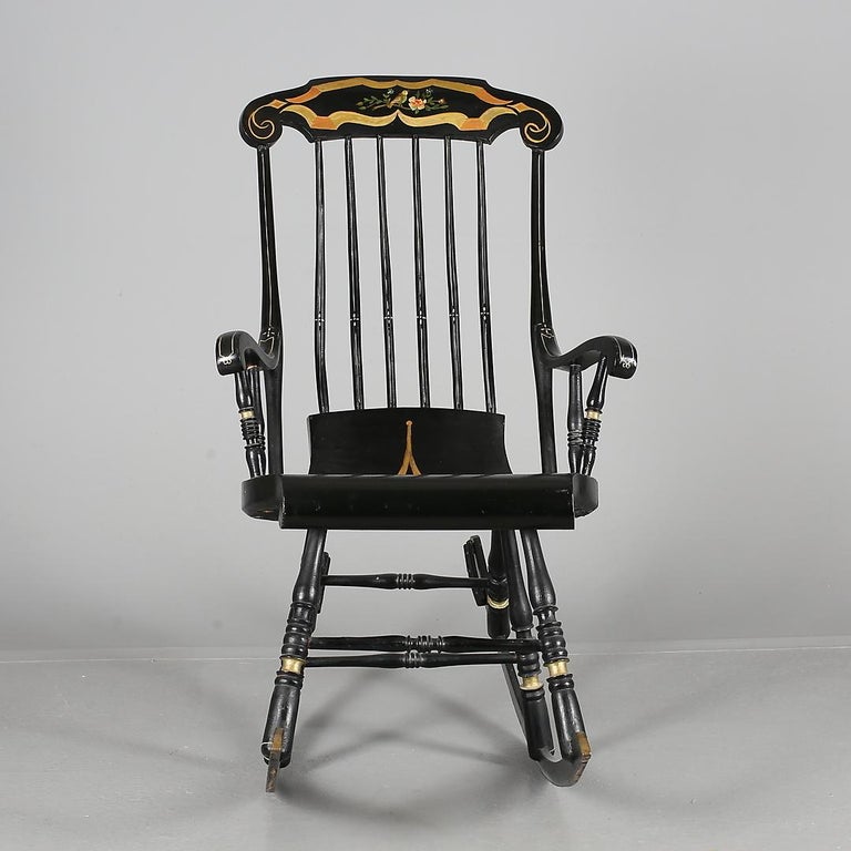 Rare Swedish antique rocking chair or Gungstol with 6 legs from the 1800s. This is the Classic Swedish rocking chair and it is beautifully painted in gold and red folk art designs on a black base.

The chair is structurally sound and has the