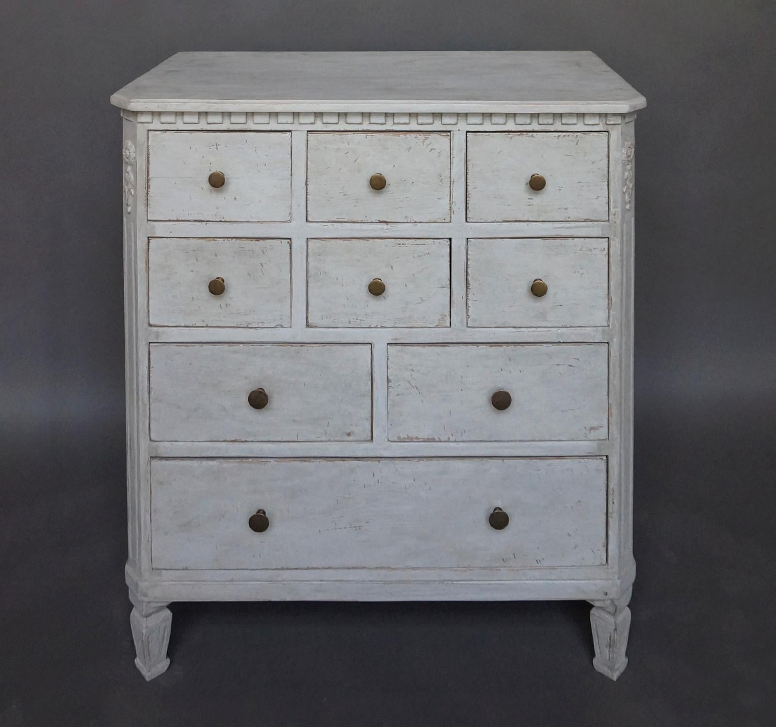 Period apothecary chest with Gustavian detail, Sweden, circa 1820. Shaped top over dentil molding and canted corners with applied rosettes and foliage. Four rows of drawers with brass pulls, all supported by tapering square feet. No repairs.