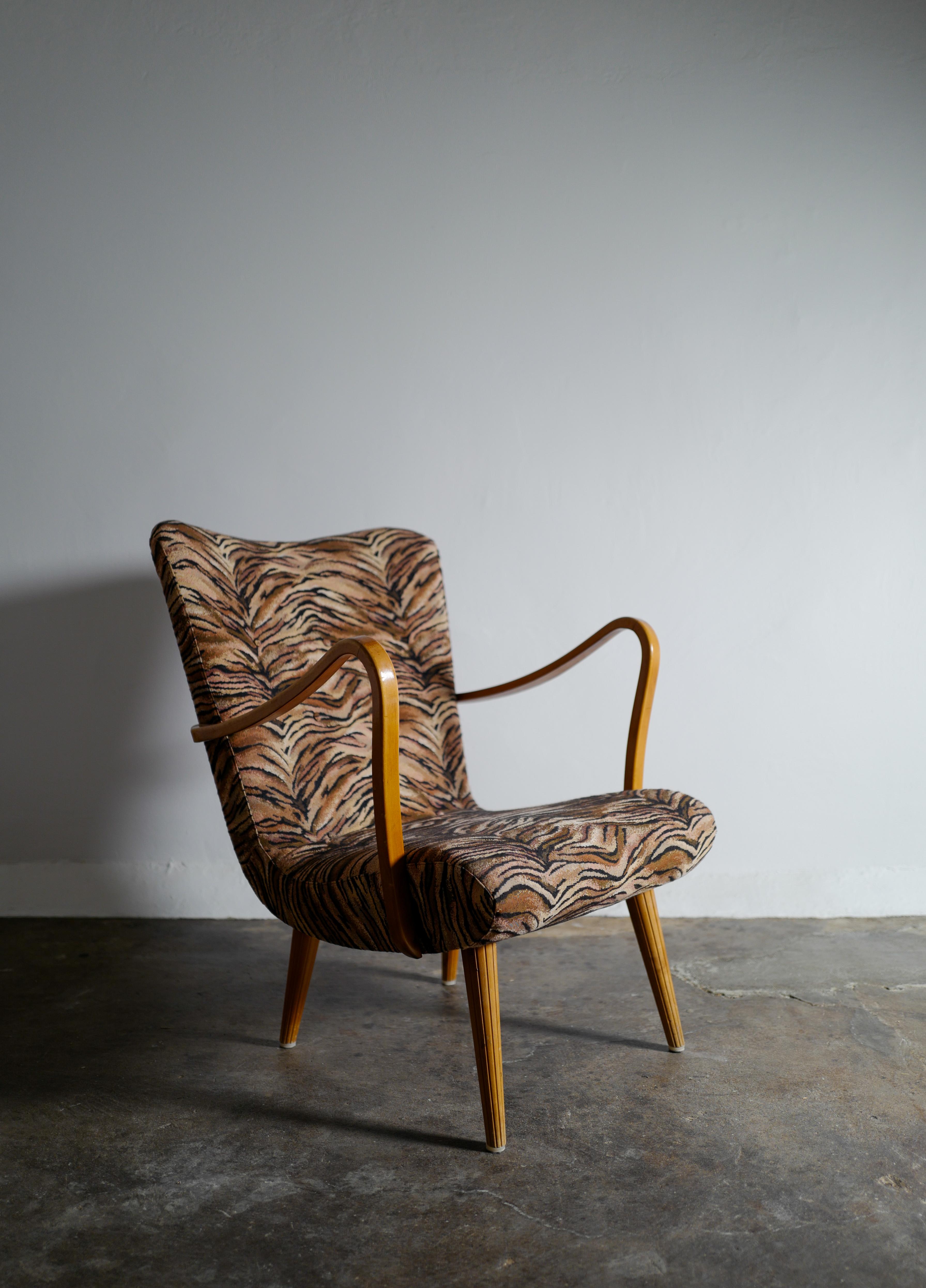 Rare armchair by unknown designer but made and produced in Sweden in good vintage condition with signs from use. The original funky zebra fabric upholstery adding some character.