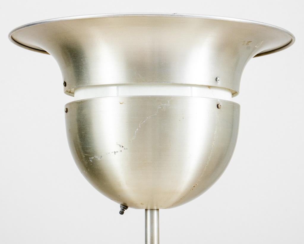 Swedish Art Deco brushed aluminum torchiere floor lamp, the Tulip-form top above a slender support on rounded base with silvered treatment, the interior with labels.

Dealer: S138XX
